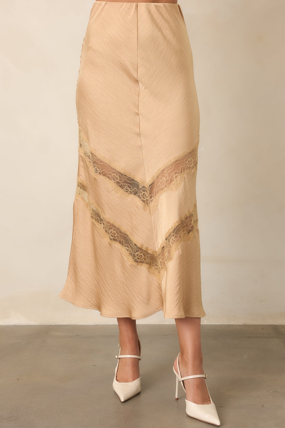 Close-up detail of the skirt showing its crinkled texture and tonal chevron lace insets.