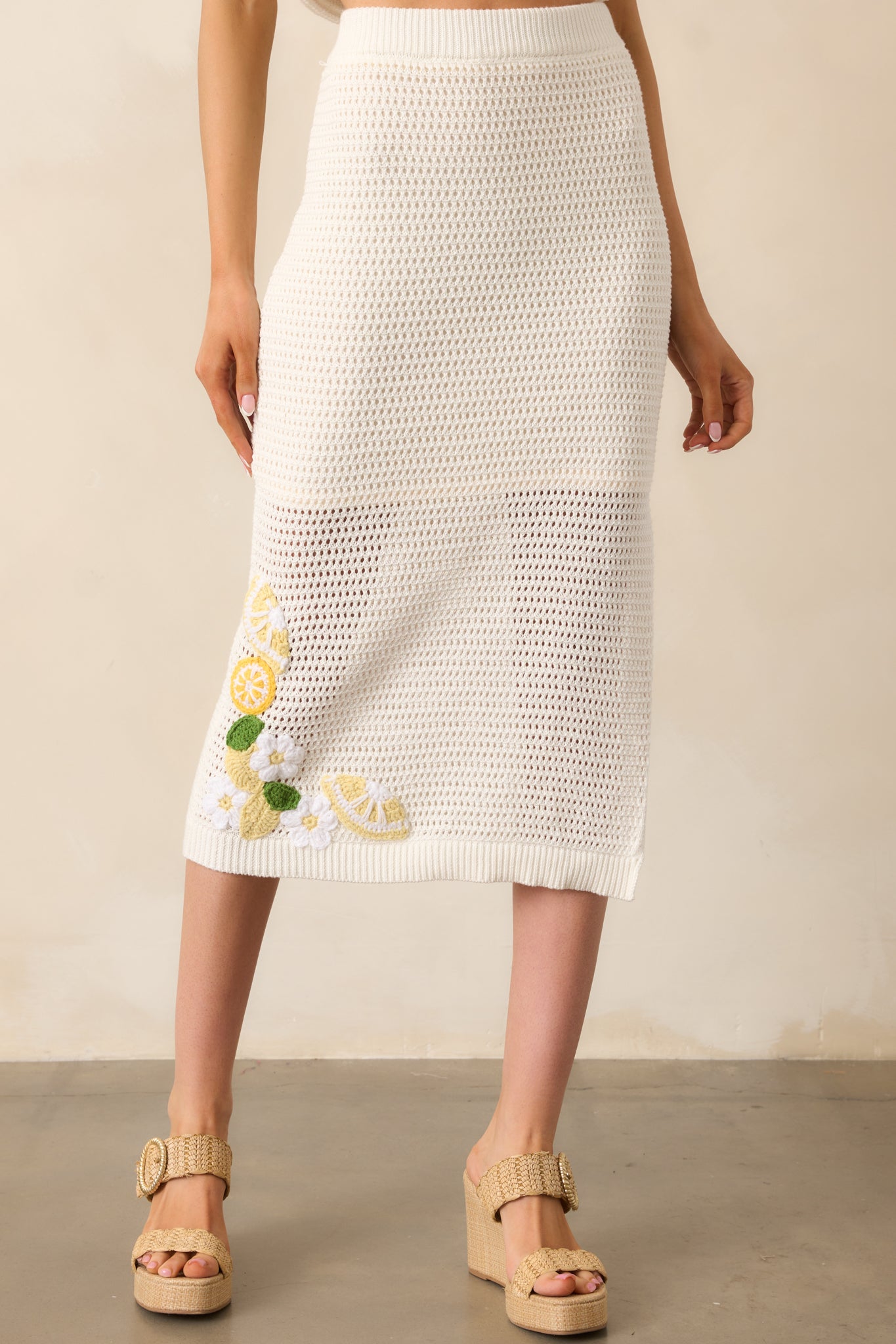 A closer look at the skirt’s fitted silhouette, showcasing the contrast between the lined and open-knit sections.