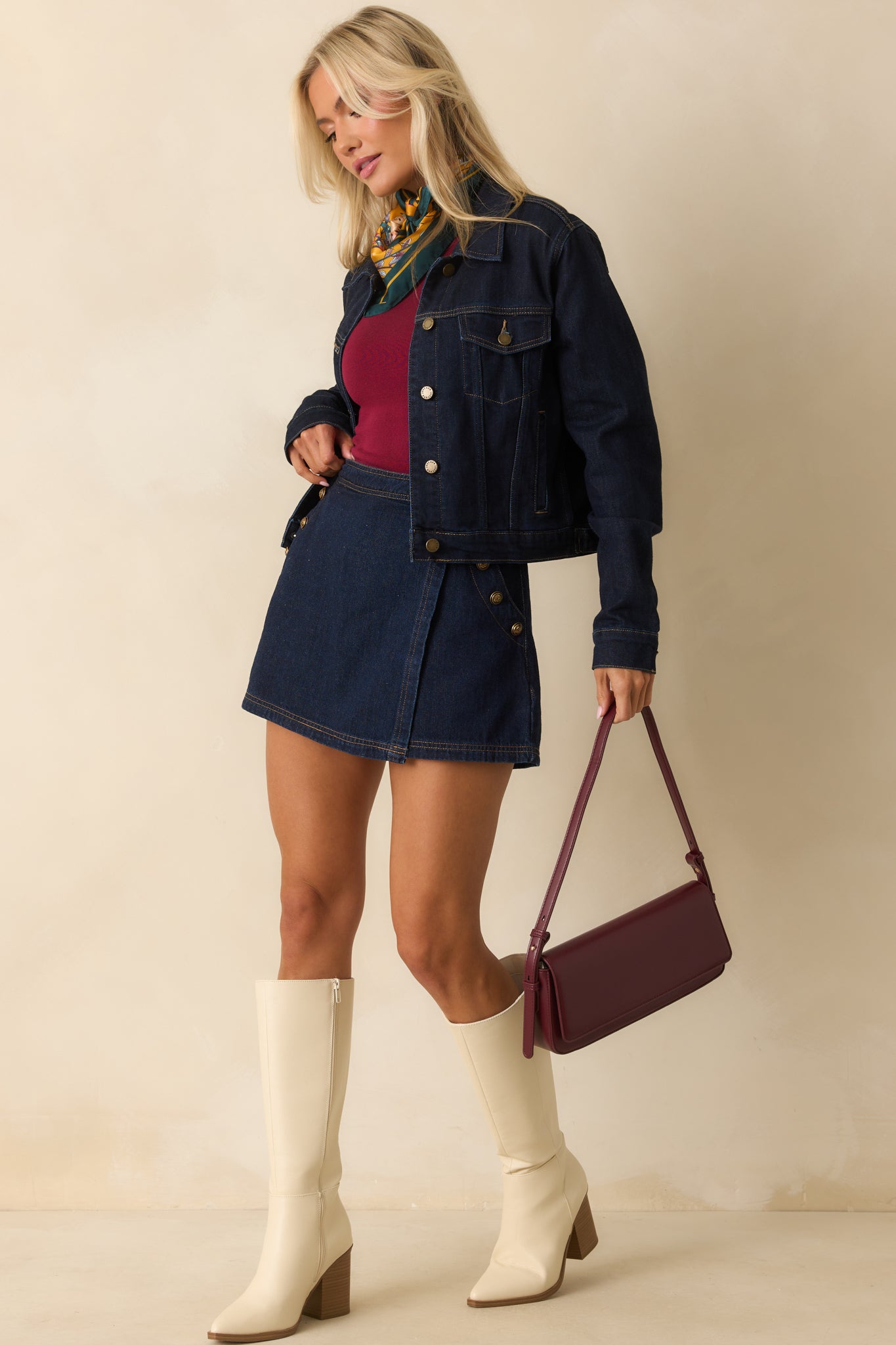 Skort featuring functional side pockets with embossed gold buttons and tan topstitching.