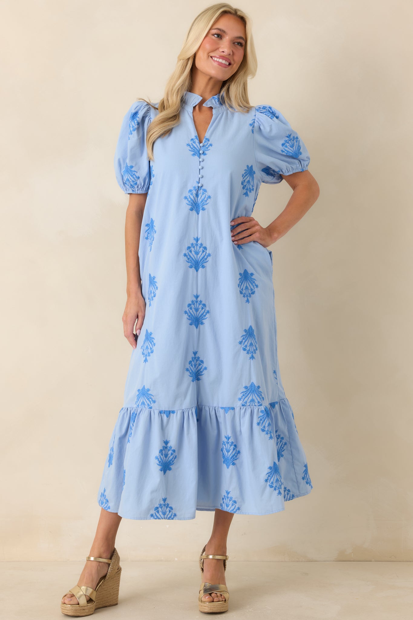 Sky blue embroidered dress featuring structured puff sleeves, tonal stitched detailing, and a lightweight skirt with graceful movement.