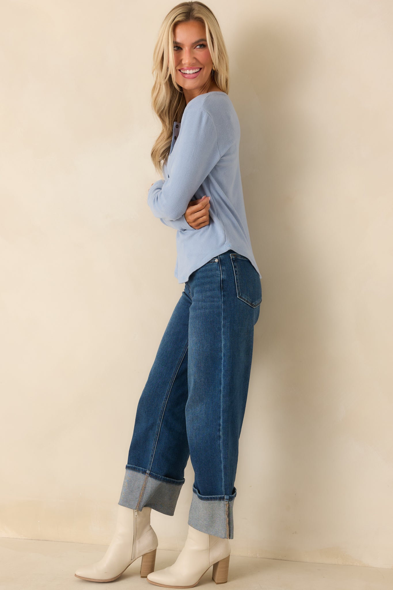 Sky blue ribbed knit top with functional buttons at the front, long sleeves, and clean straight hemline.