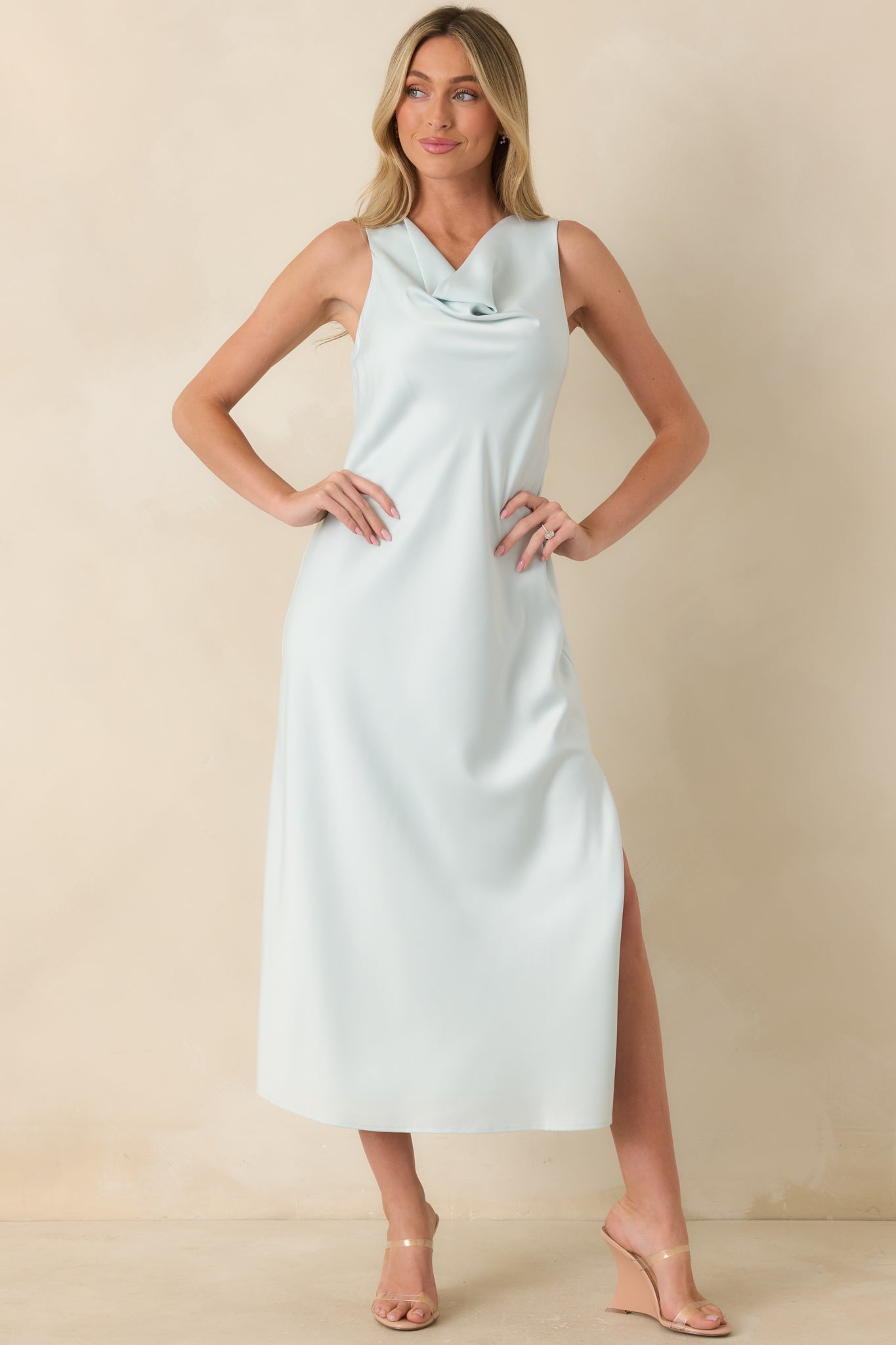 Sky blue satin midi dress with gentle cowl neckline, subtle sheen, and an easy side slit.