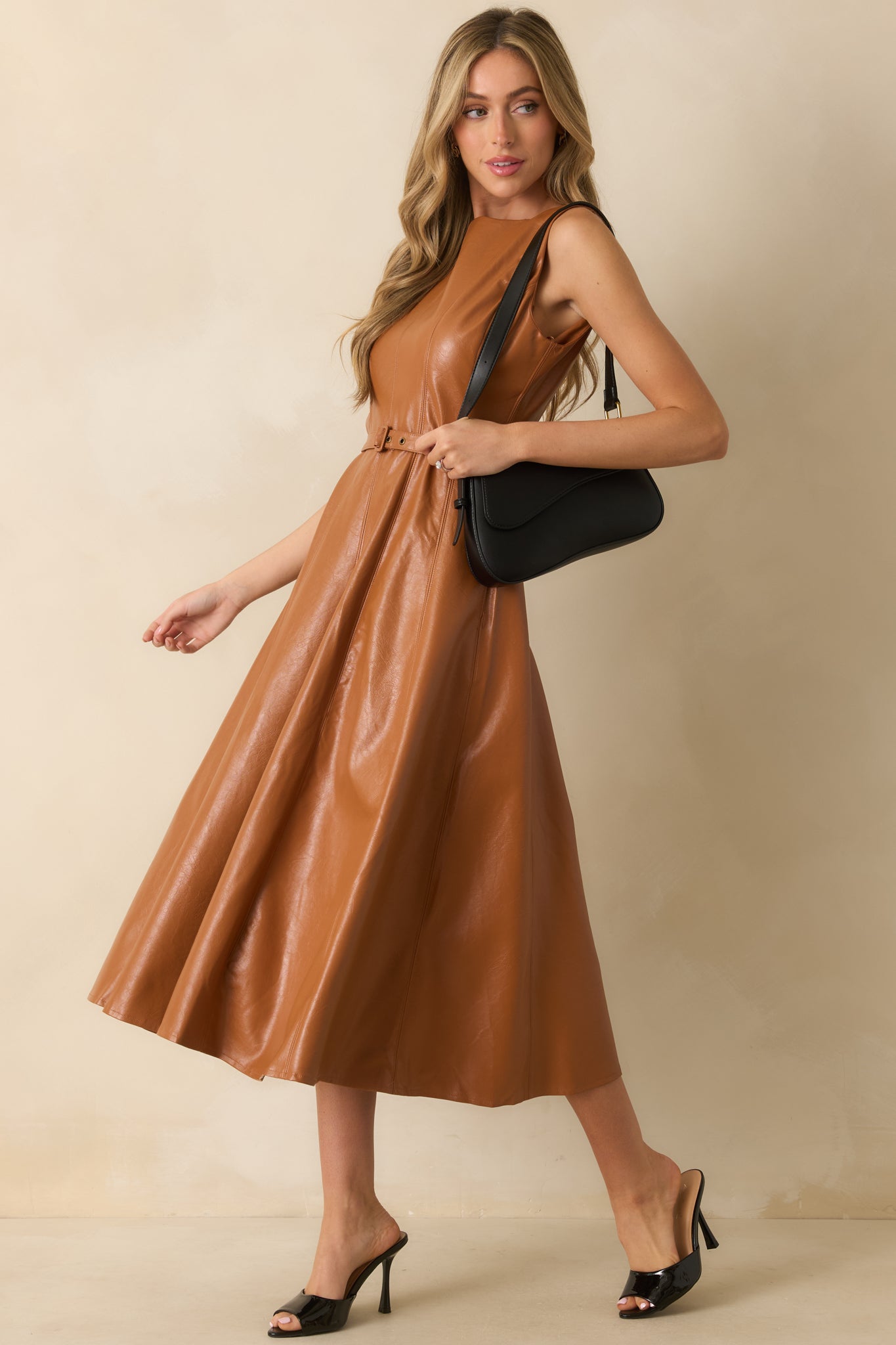 Sleek caramel dress with paneled design, round neckline, and functional side pockets.