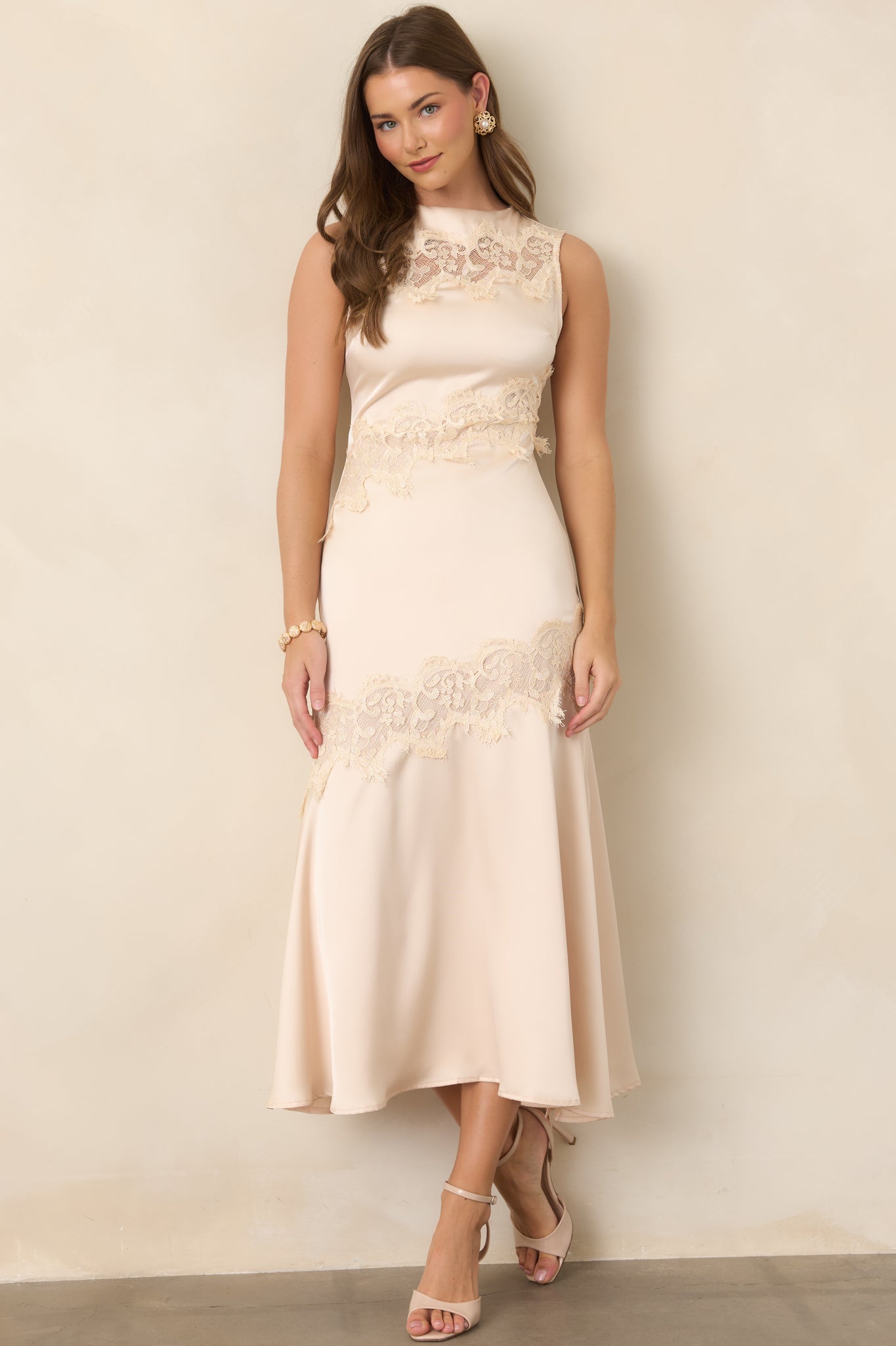 Sleeveless champagne midi dress with intricate lace accents framing the bodice and lower skirt.