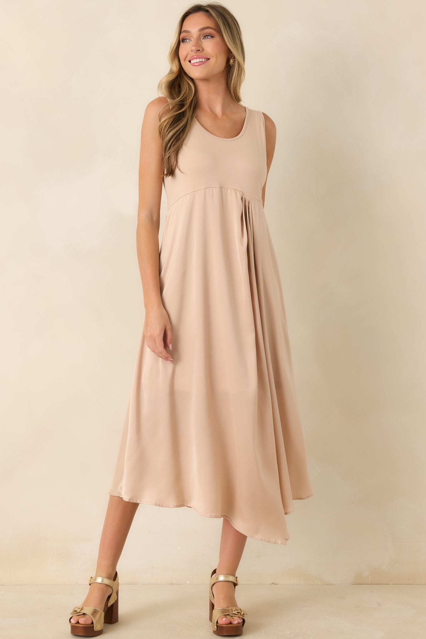 Champagne midi dress showcasing a sleeveless design with a smooth stretch-knit bodice and graceful satin skirt.