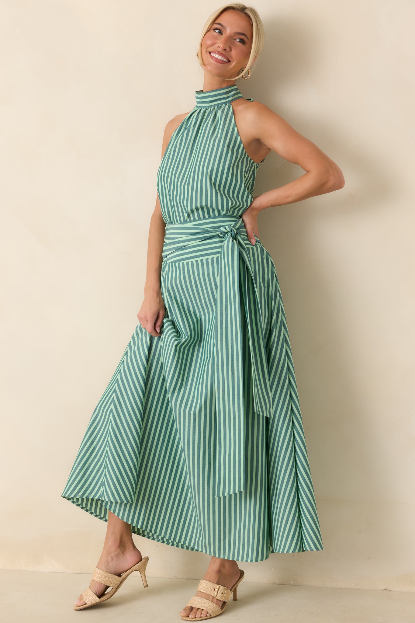 Sleeveless cotton halter top featuring a relaxed silhouette, alternating dark green and mint stripes, and a softly gathered high neckline for an effortless look.