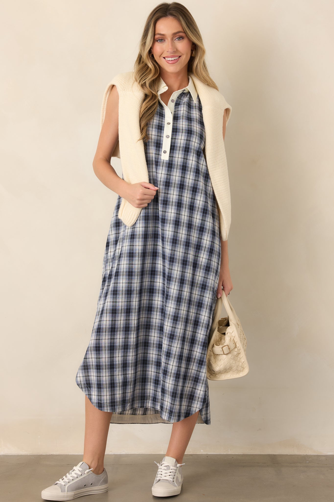 Sleeveless cotton dress showcasing its crisp collar, ivory-trimmed neckline, partial button front, and comfortable flowing shape.