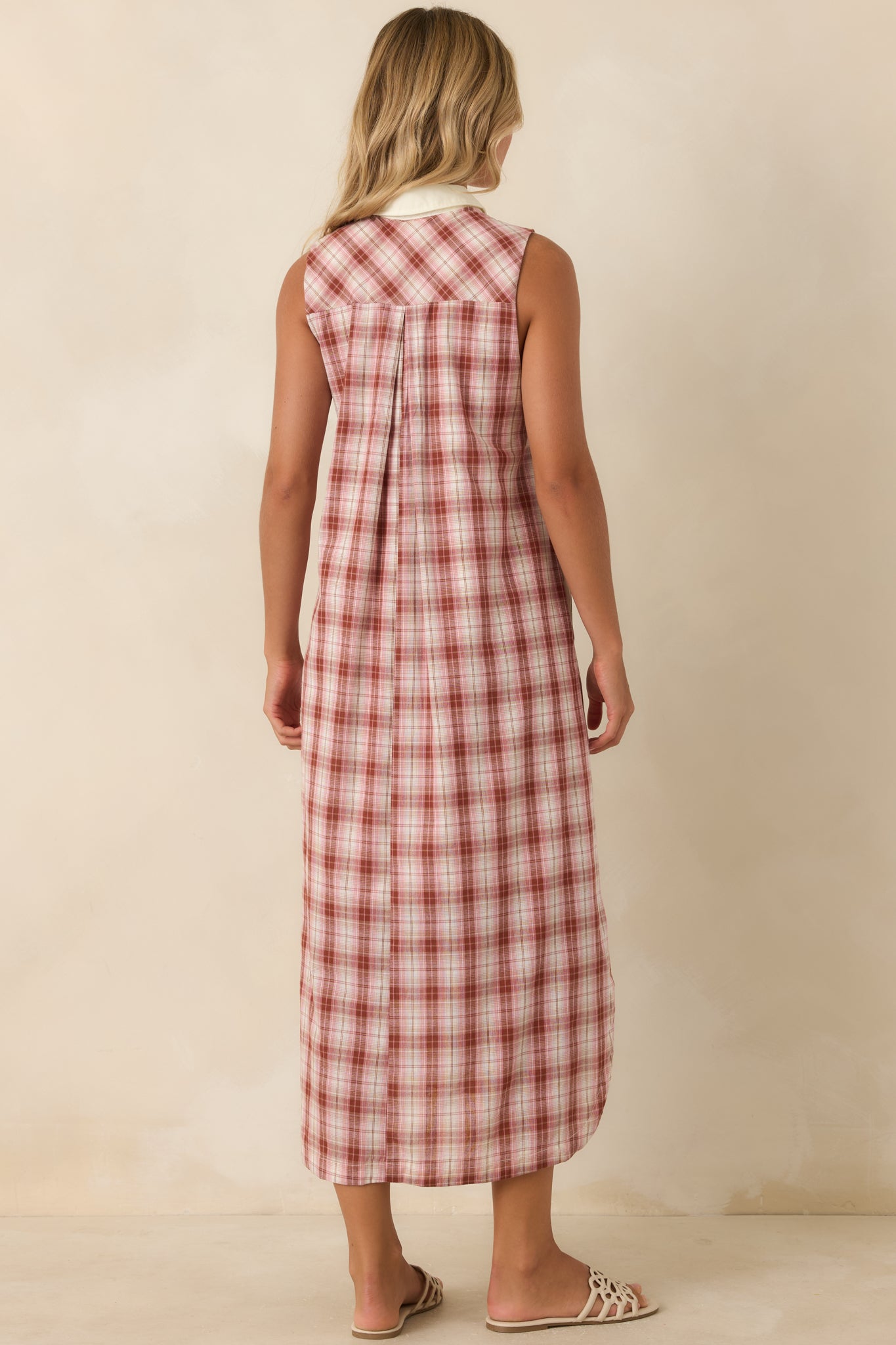 Rear view of the sleeveless cotton dress featuring a relaxed fit, smooth lining, and clean silhouette.