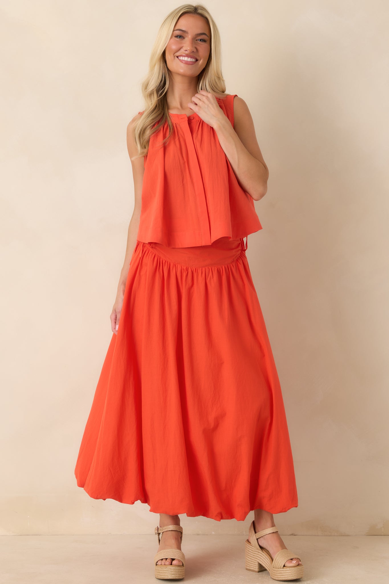 Breezy sleeveless cotton top showcasing a flowing shape, full button front placket, and softly gathered neckline for an effortless everyday look.