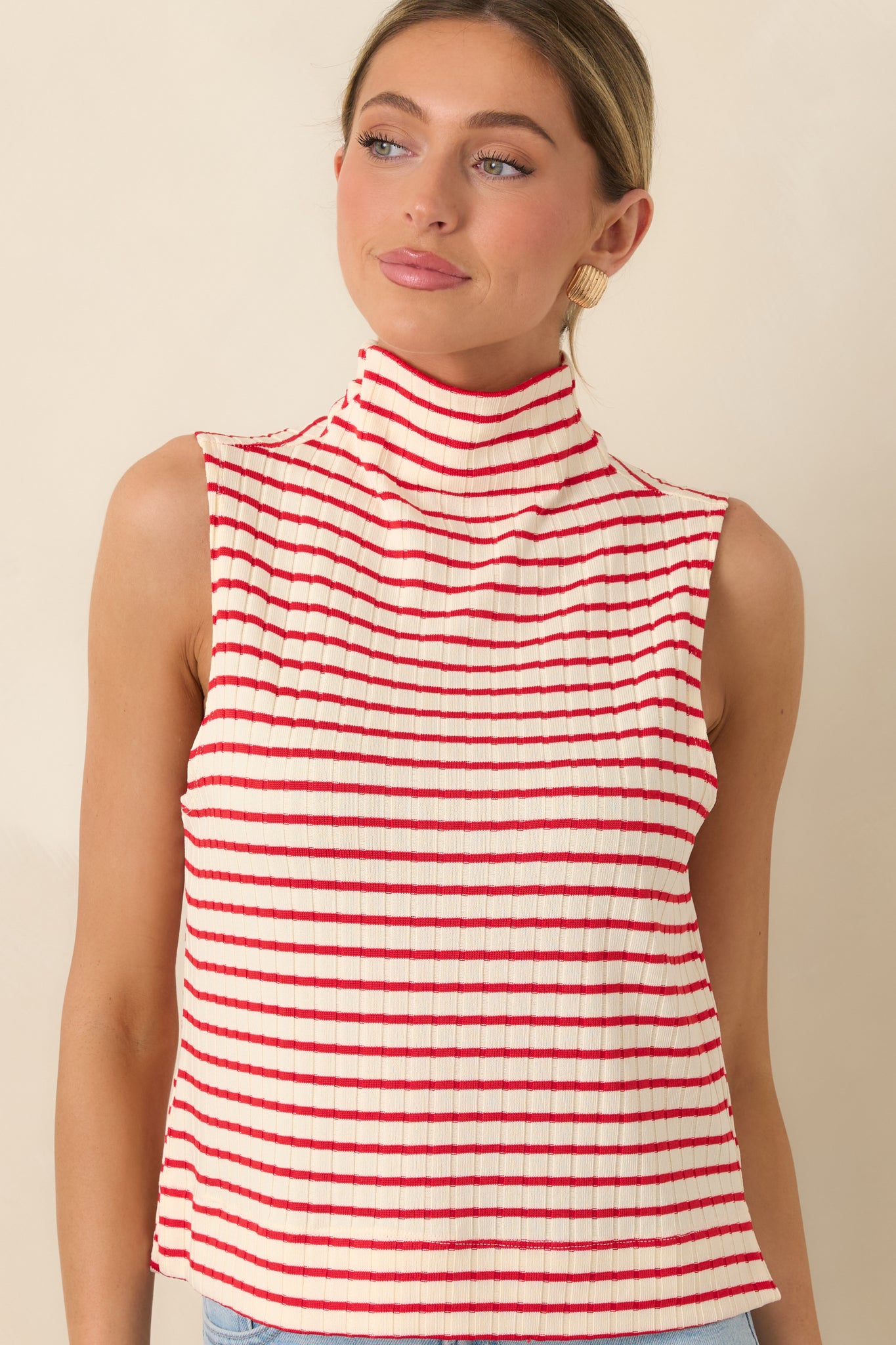 Sleeveless cut highlighting fitted ribbed fabric and stripe pattern.