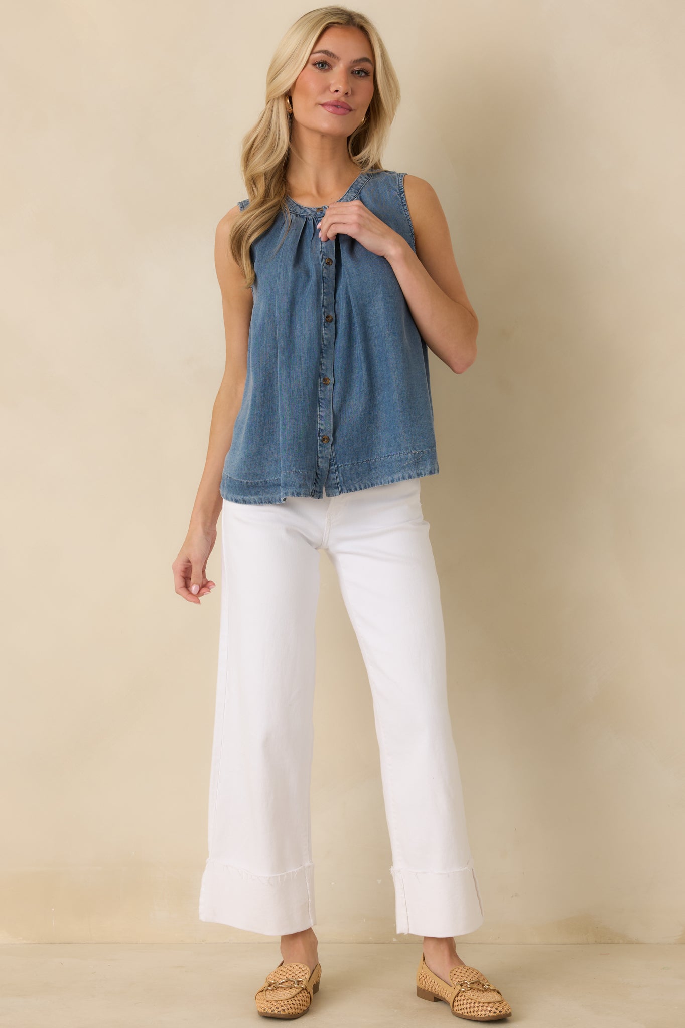 Front view of the sleeveless denim-style top showing soft gathering at the neckline and breathable construction.