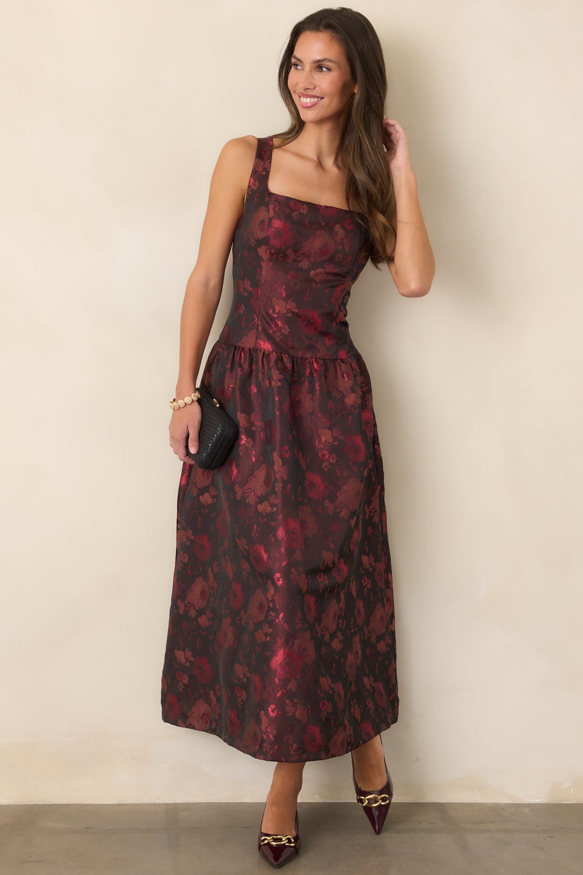 Sleeveless floral midi dress with a defined bodice and flowing gathered skirt.