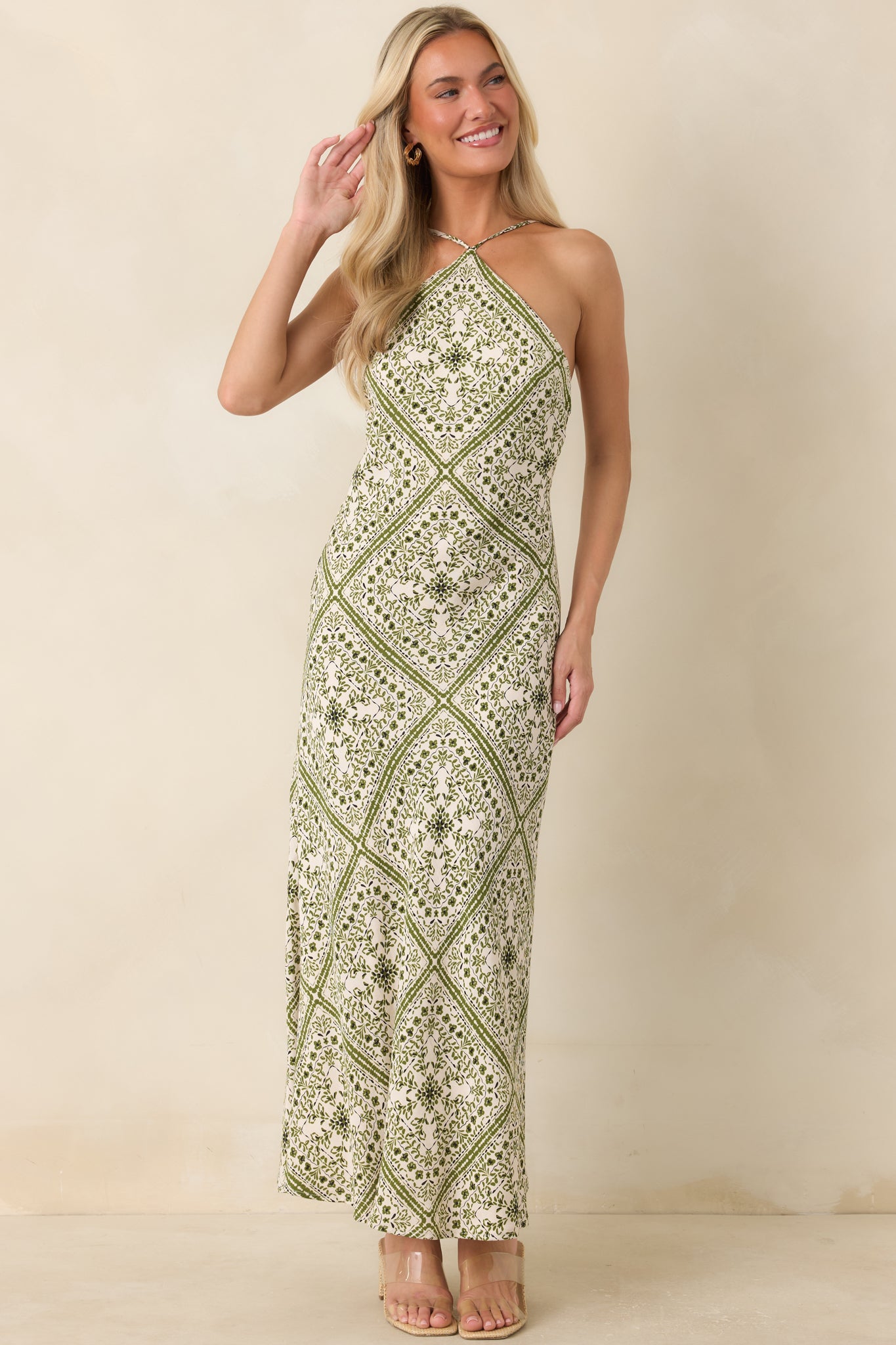 Sleeveless floral midi dress featuring a sleek silhouette, polished neckline, and timeless romantic style.