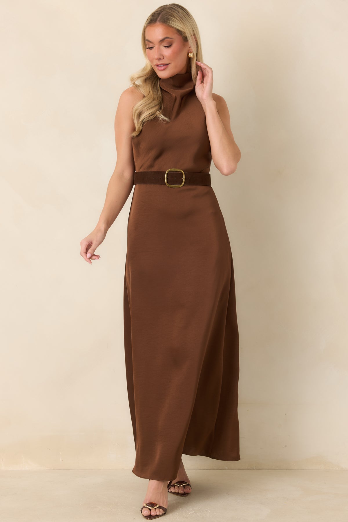 Sleeveless maxi dress featuring a fitted bodice, gently flared skirt, and brown faux suede belt with an antiqued gold-tone buckle.