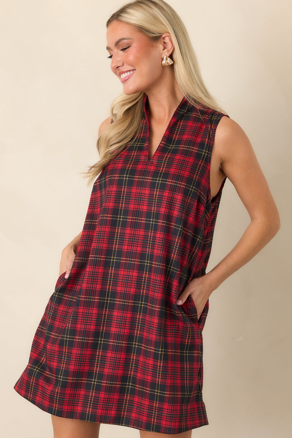 Sleeveless plaid dress with fine contrasting lines, a relaxed shift silhouette, and clean standing neckline.