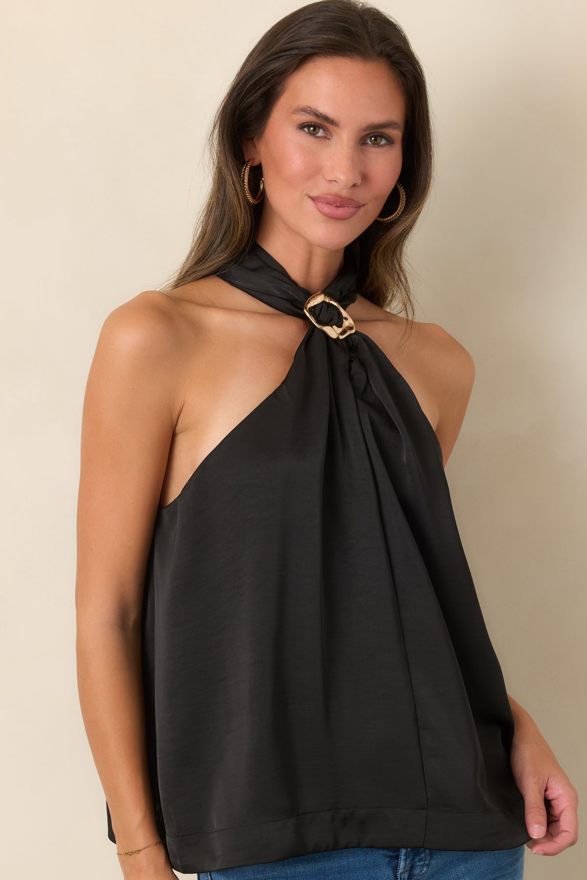 The exposed shoulder design complements the decorative ring accent at the neckline of this sleeveless top.
