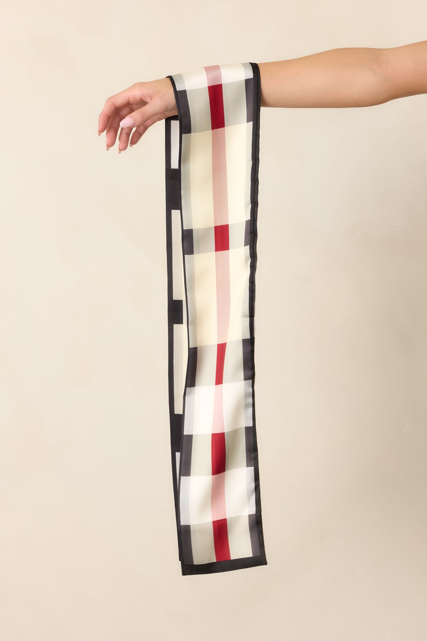 Slim hair scarf featuring a contrasting dark border and lightweight design for versatile styling around the neck, hair, or handbag.