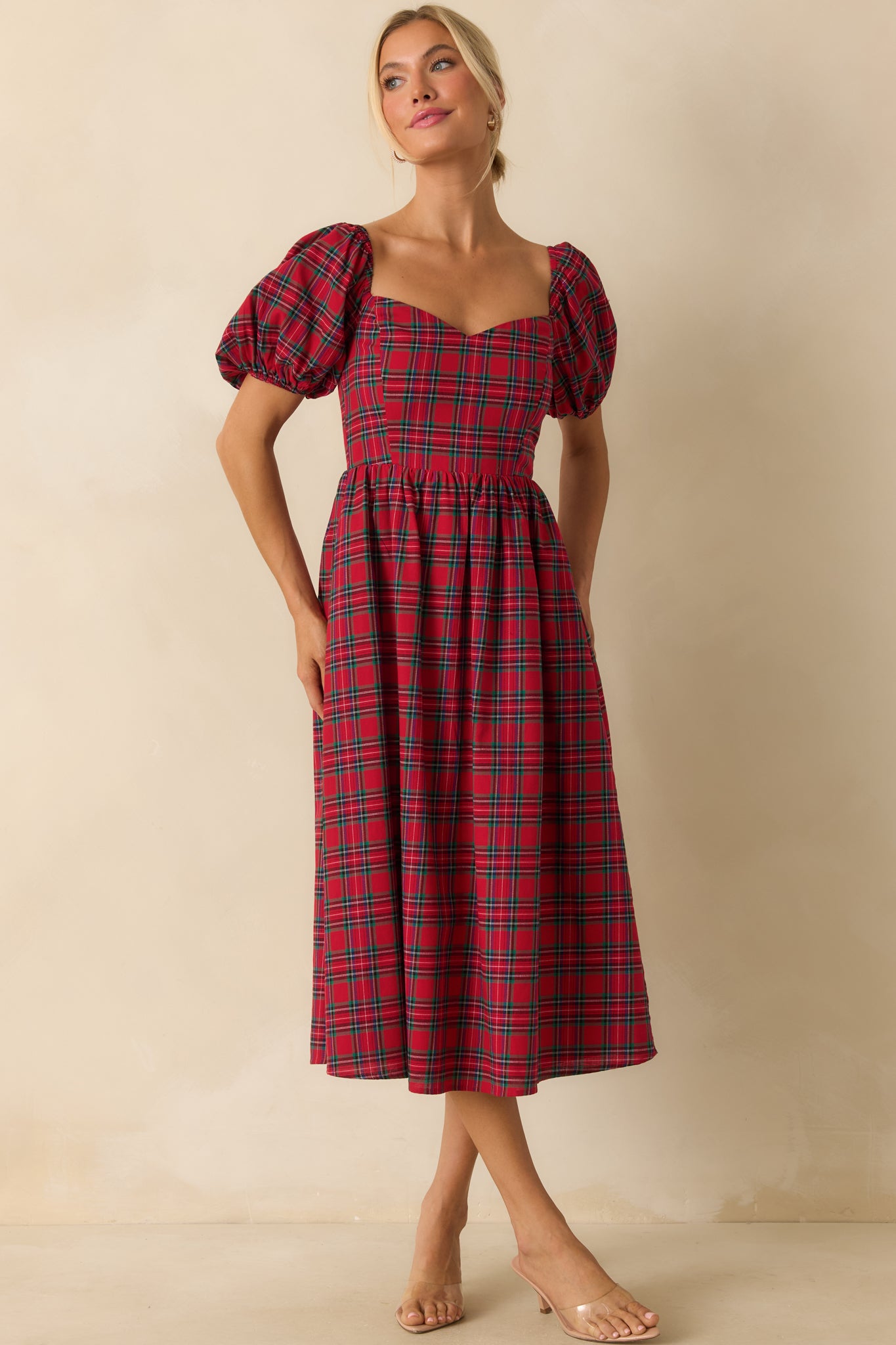 Slim-fit red plaid dress with short puff sleeves and a gently fitted front silhouette.