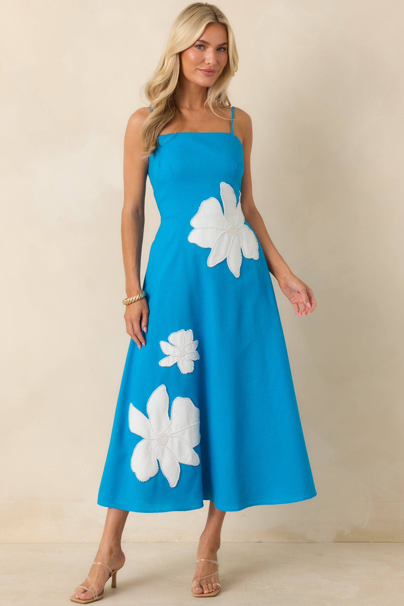 Elegant midi dress featuring a comfortable smocked back panel, adjustable straps, side pockets, and a breezy A-line silhouette.