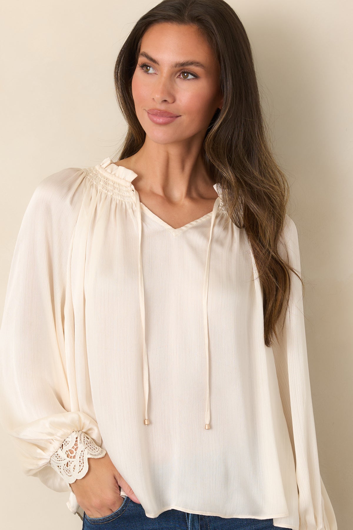 A smocked ruffle neckline surrounds the V-shaped opening of this softly textured top.