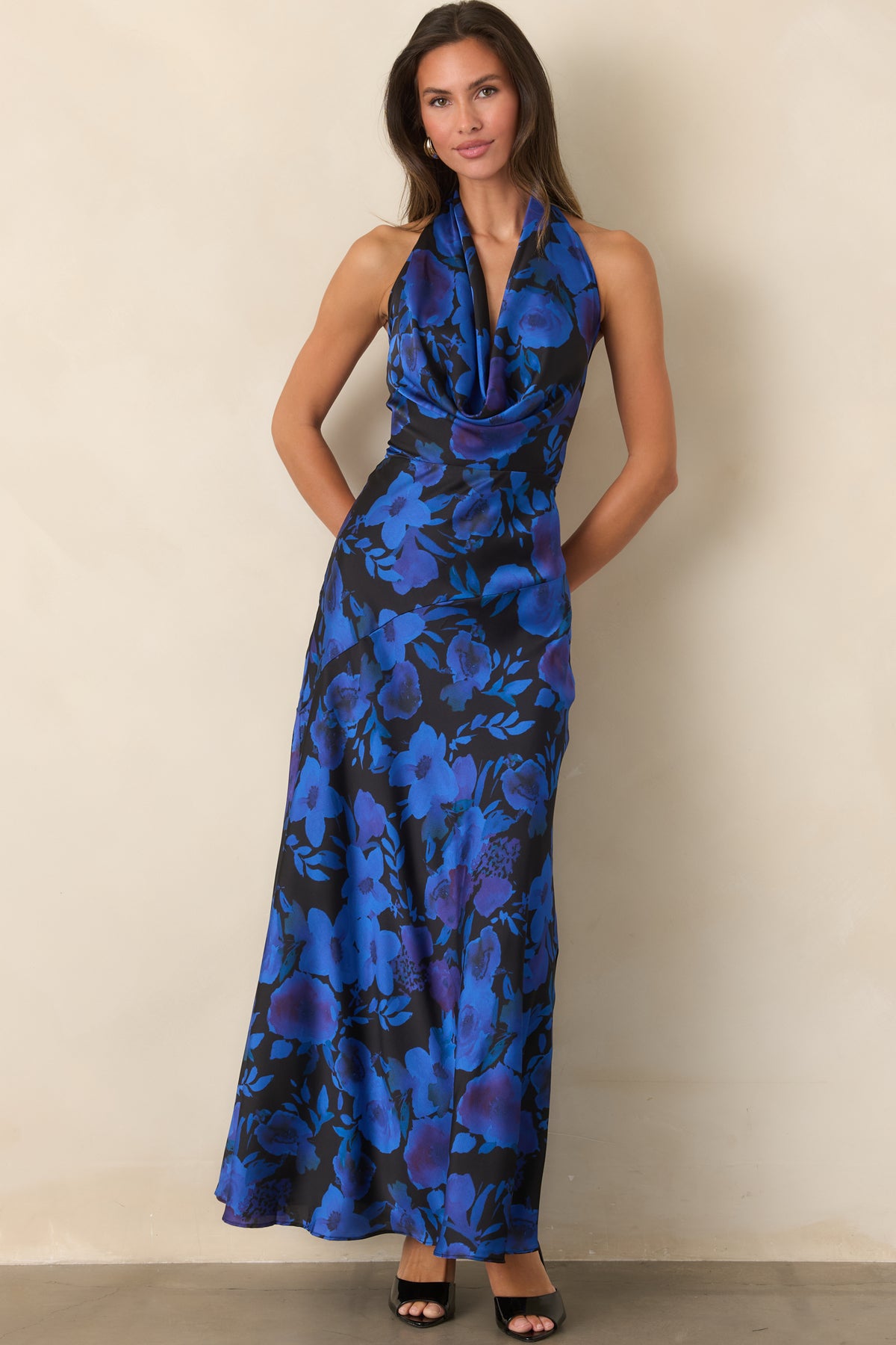 Smooth black satin dress showcasing vivid blue and violet florals and an elegant A-line maxi silhouette.