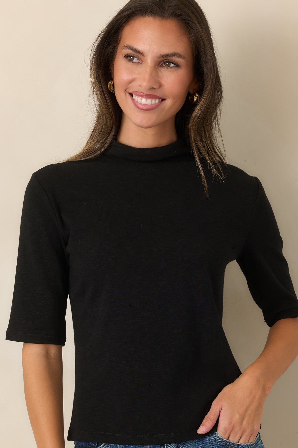 Smooth knit texture gives this short-sleeve top a polished look with a defined high neckline.
