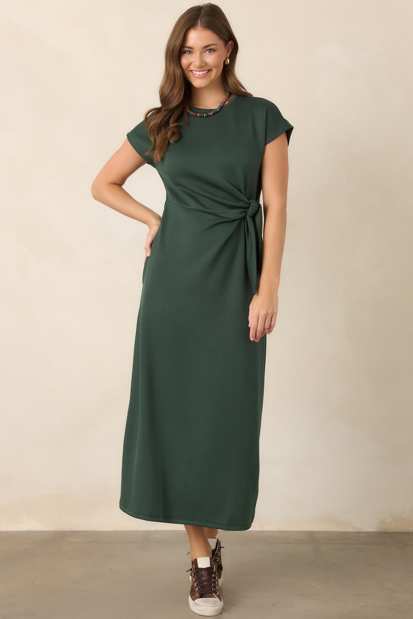 Smooth stretch dress with a fluid midi silhouette, comfortable fit, and sculpted waist knot adding gentle definition through the center.