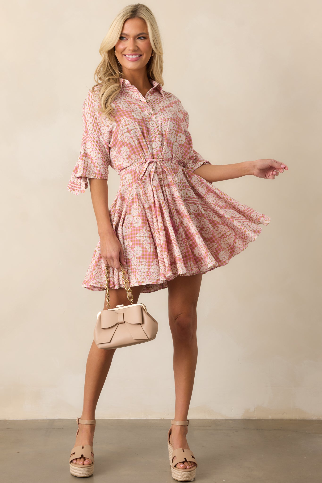 A soft and airy dress with a mix of gingham and floral patterns, a relaxed fit, and delicate feminine details.