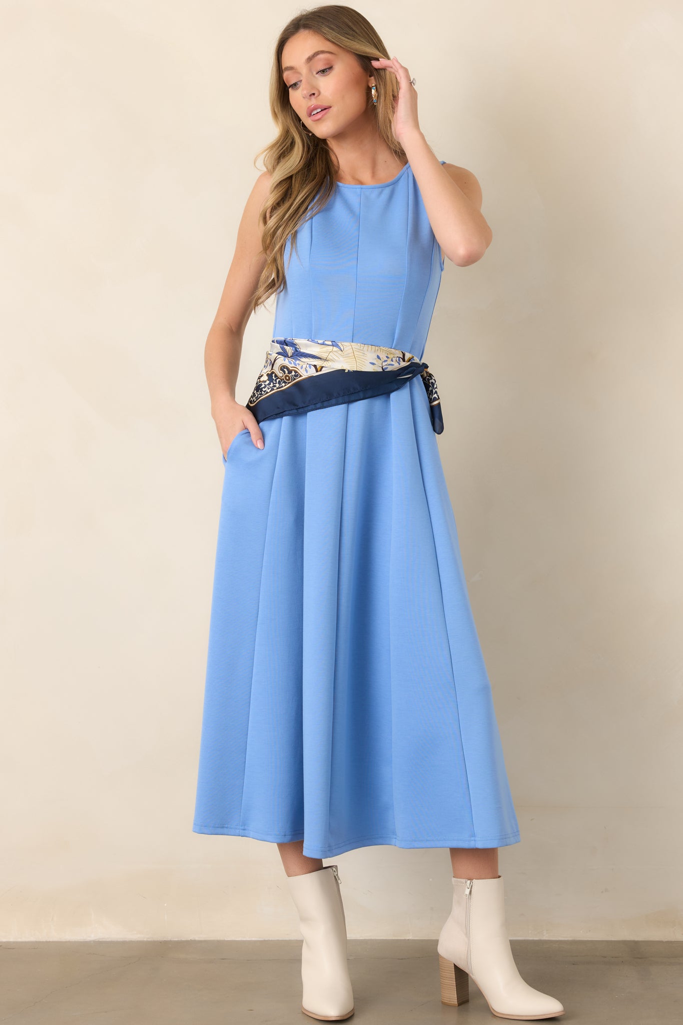 Soft blue pull-on midi dress showcasing a smooth drape, clean round neckline, and gently structured panel detailing.