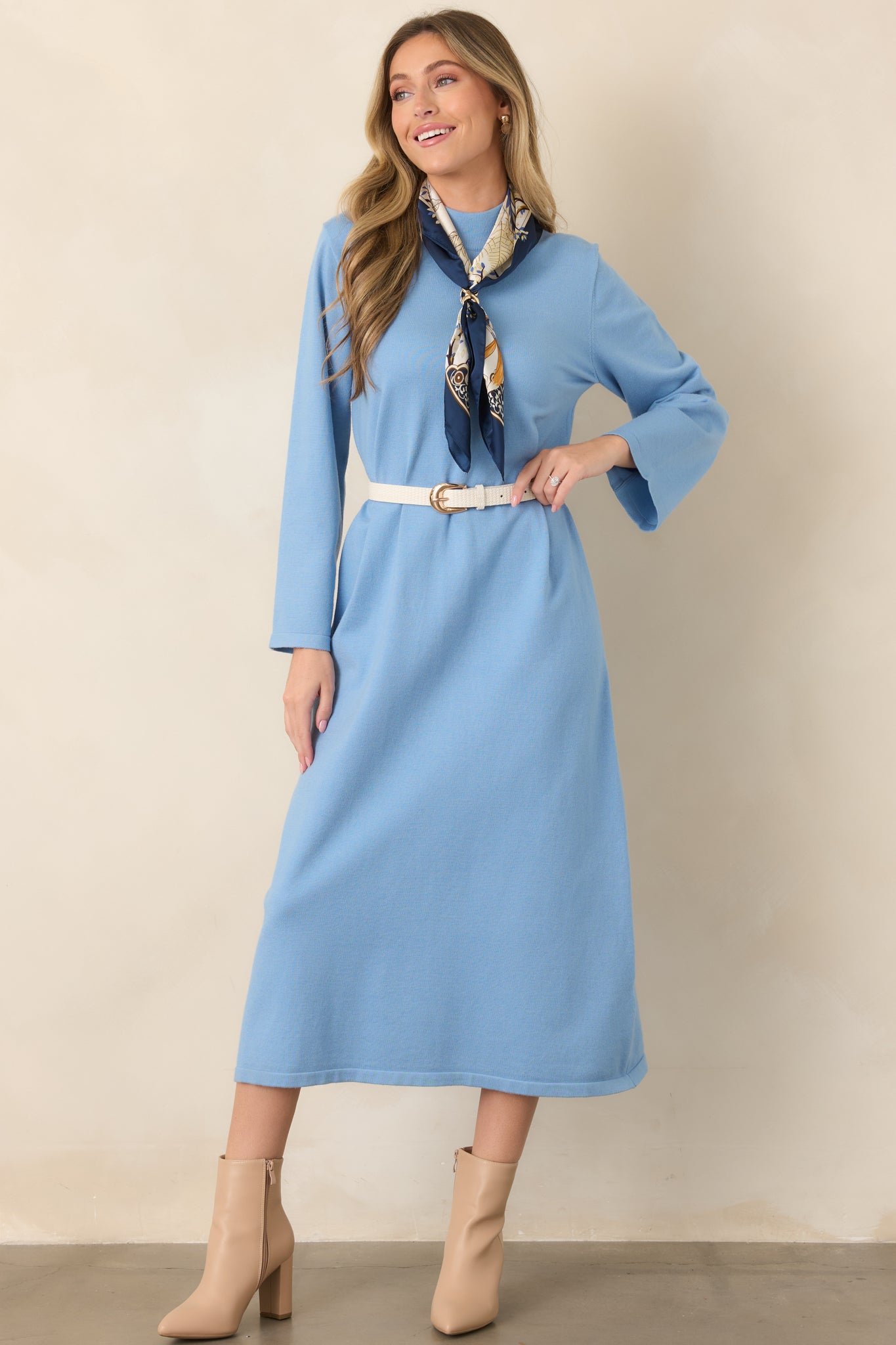 Soft stretch knit midi dress in light blue with a straight shape, understated mock collar, and full-length sleeves.