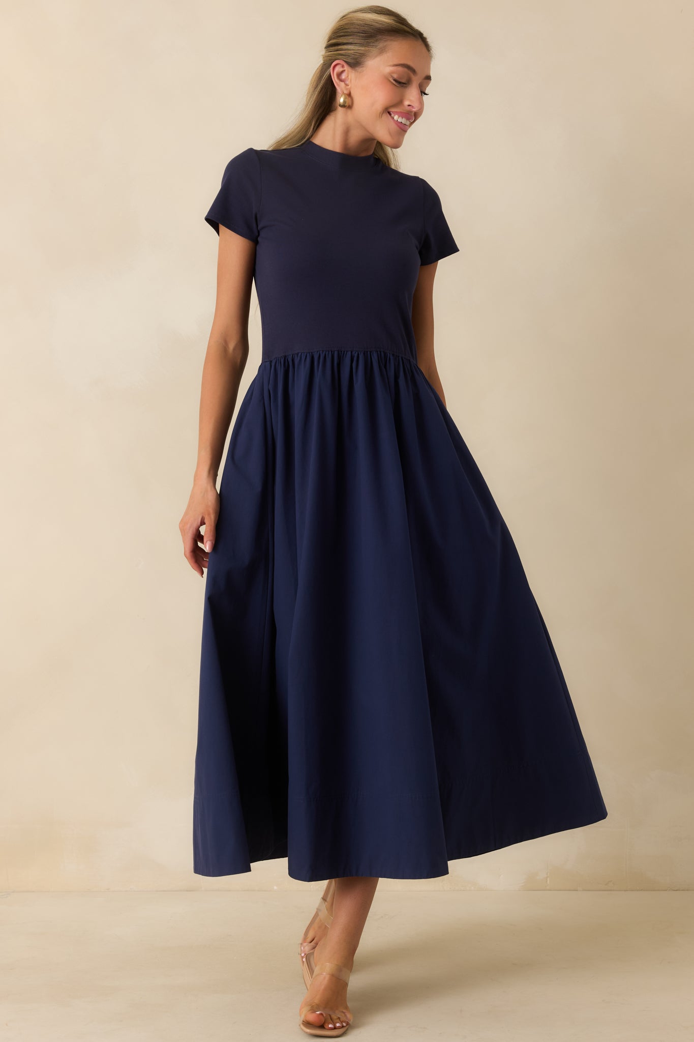 Soft cotton dress featuring a fitted upper silhouette and voluminous midi-length skirt with effortless movement.