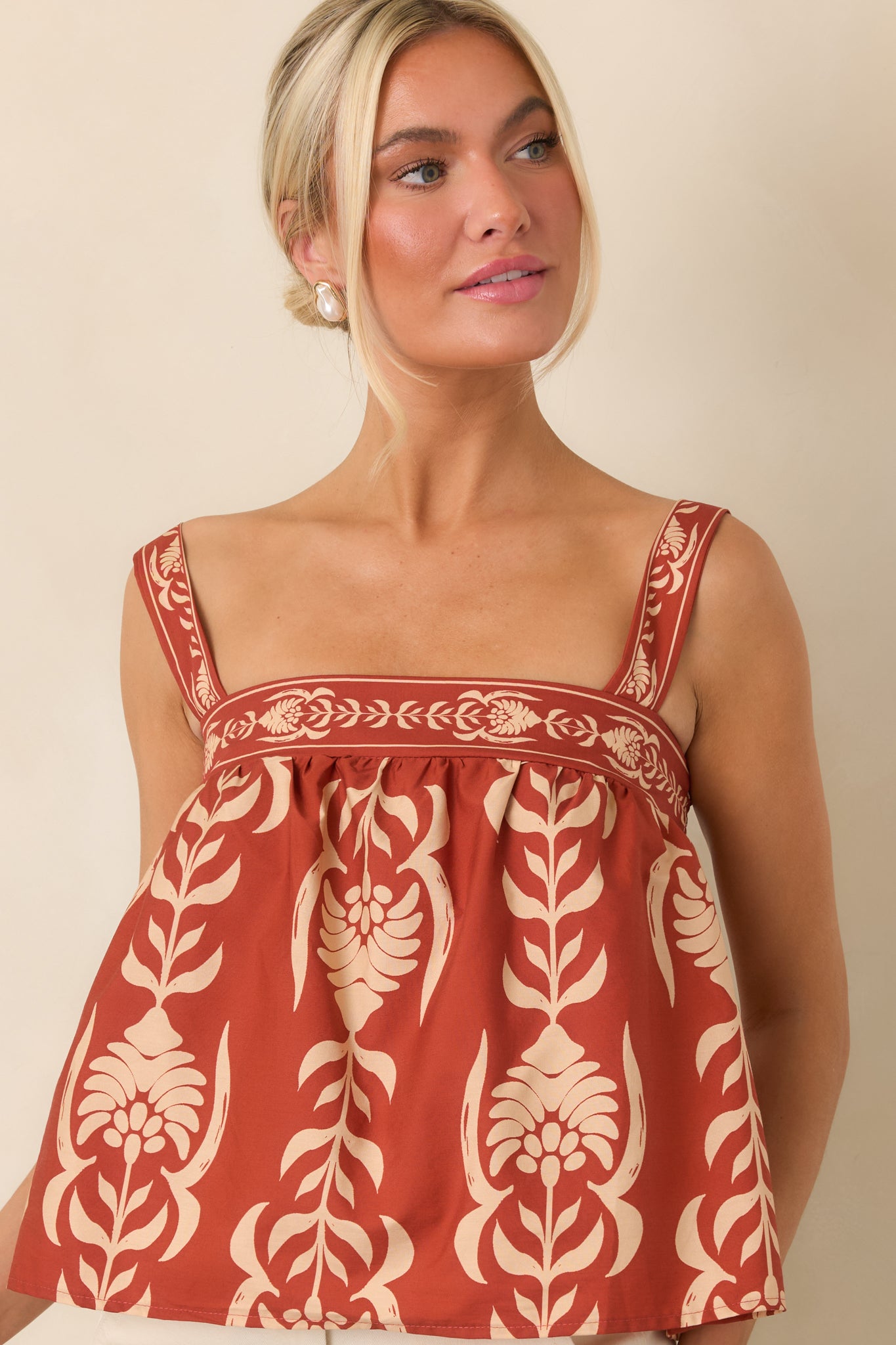 Soft cotton top showcasing its gathered fabric, relaxed shape, and feminine babydoll-inspired silhouette.