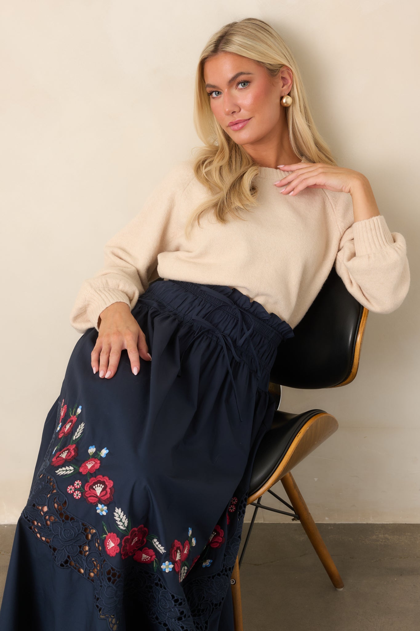 Plush knit top in soft ecru with a relaxed cropped silhouette, rounded crew neck, long raglan sleeves, and ribbed hem.