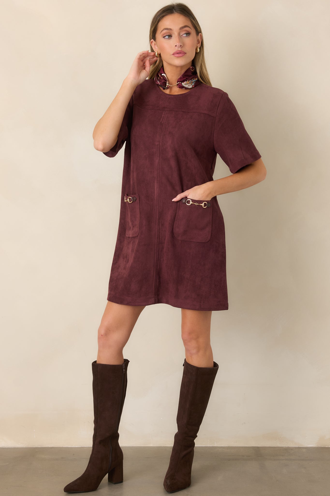 Soft faux suede dress showcasing its smooth stretch construction, short-sleeve silhouette, round neckline, and decorative gold-tone horsebit hardware.