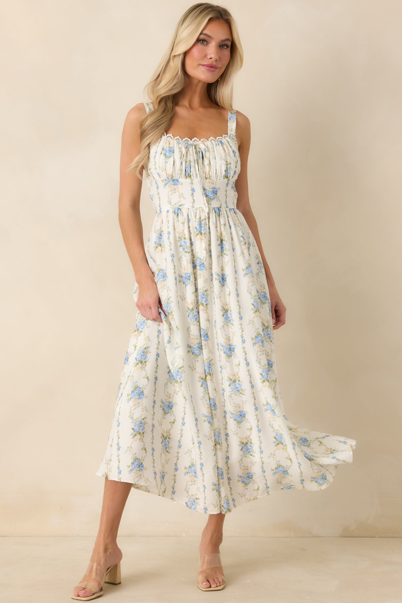 Soft floral midi dress with adjustable shoulder straps, textured ruching at the neckline.