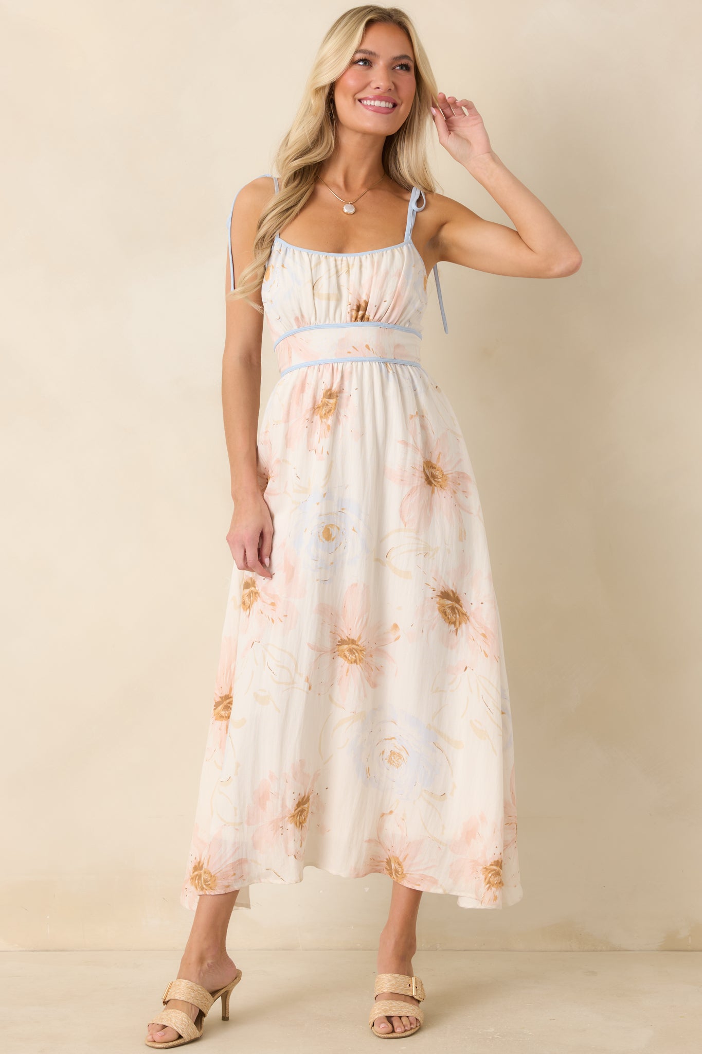 Soft floral print dress featuring a smocked back, delicate straps, and a flattering midi length.