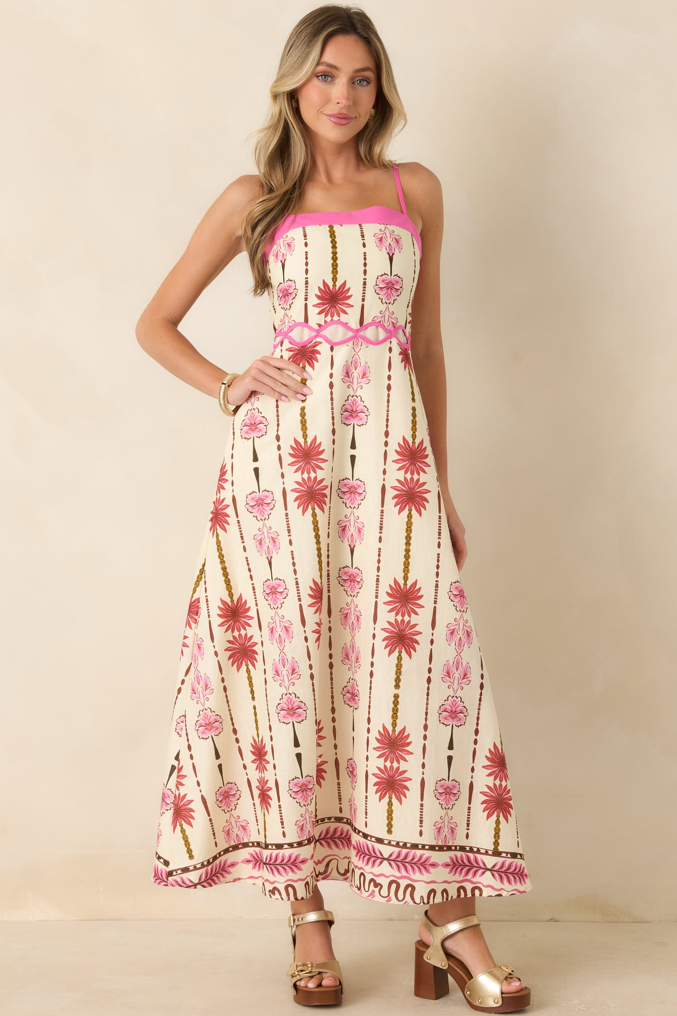 Soft floral print maxi dress with a straight neckline, flexible smocked bodice, and elegant A-line shape.