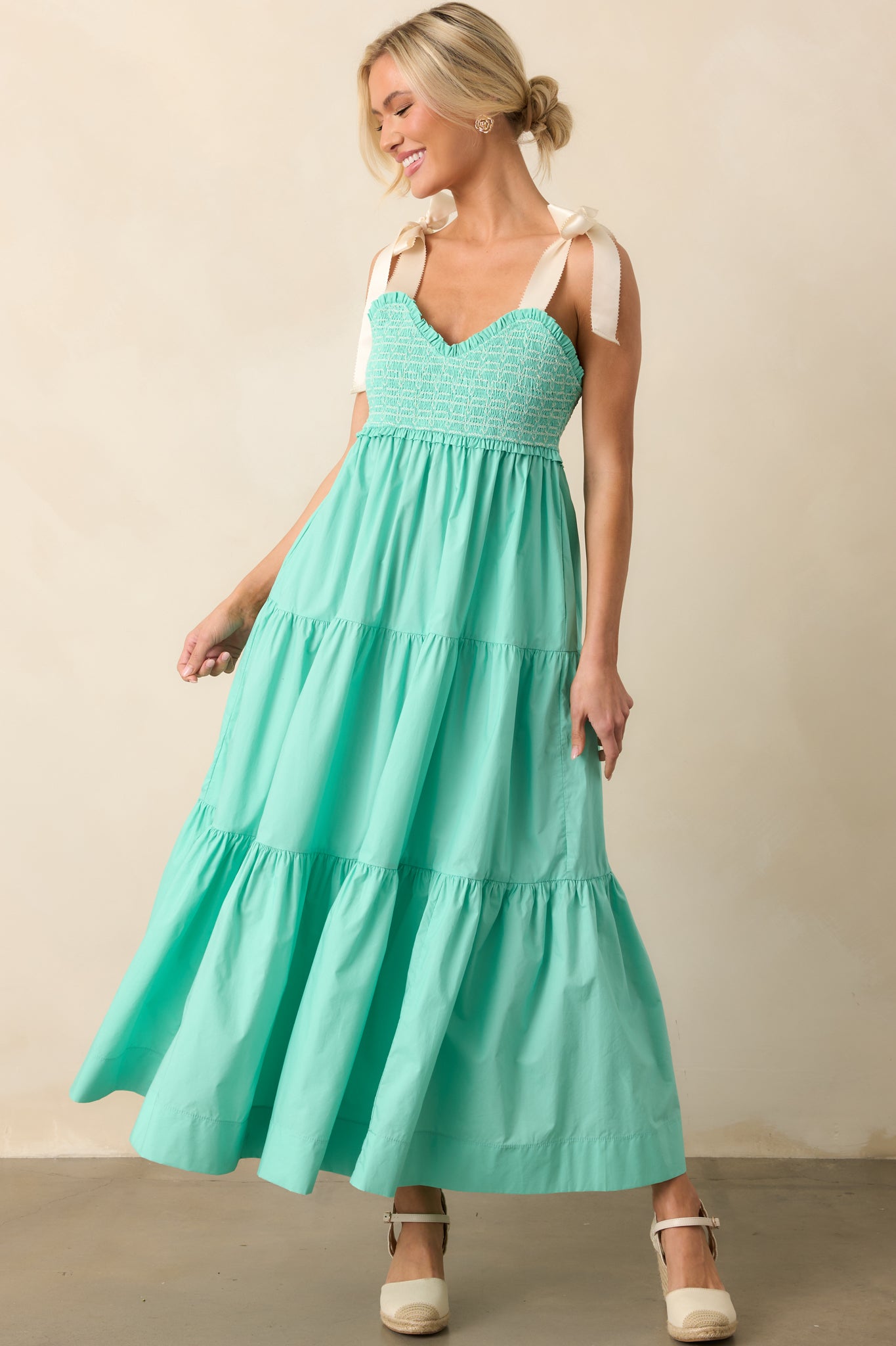 The soft, flowy skirt of this midi dress complements the structured smocked bodice and delicate embroidery.