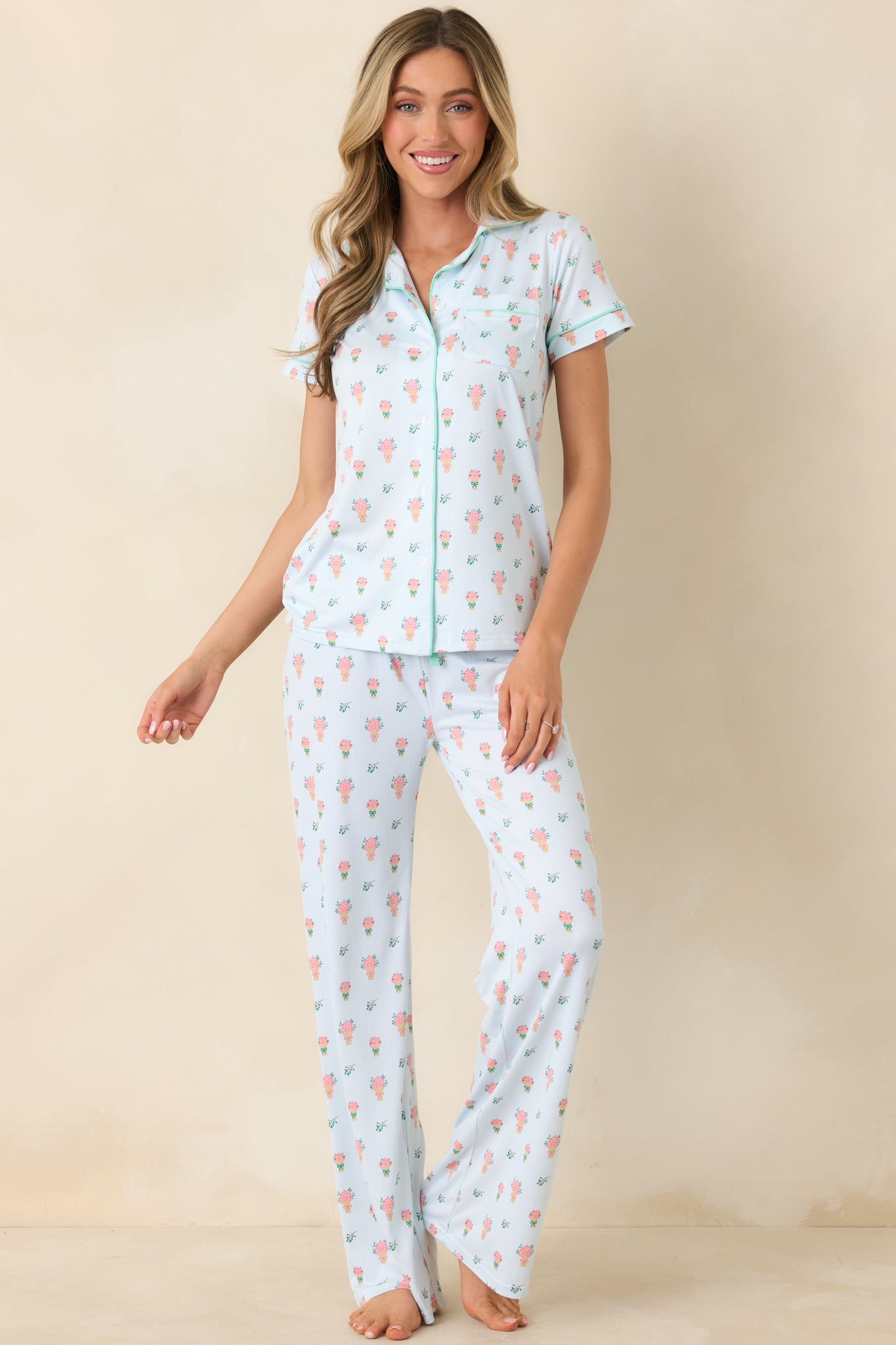Soft green floral pants featuring an easy drape and elastic waistband with adjustable drawstring for a customizable fit.