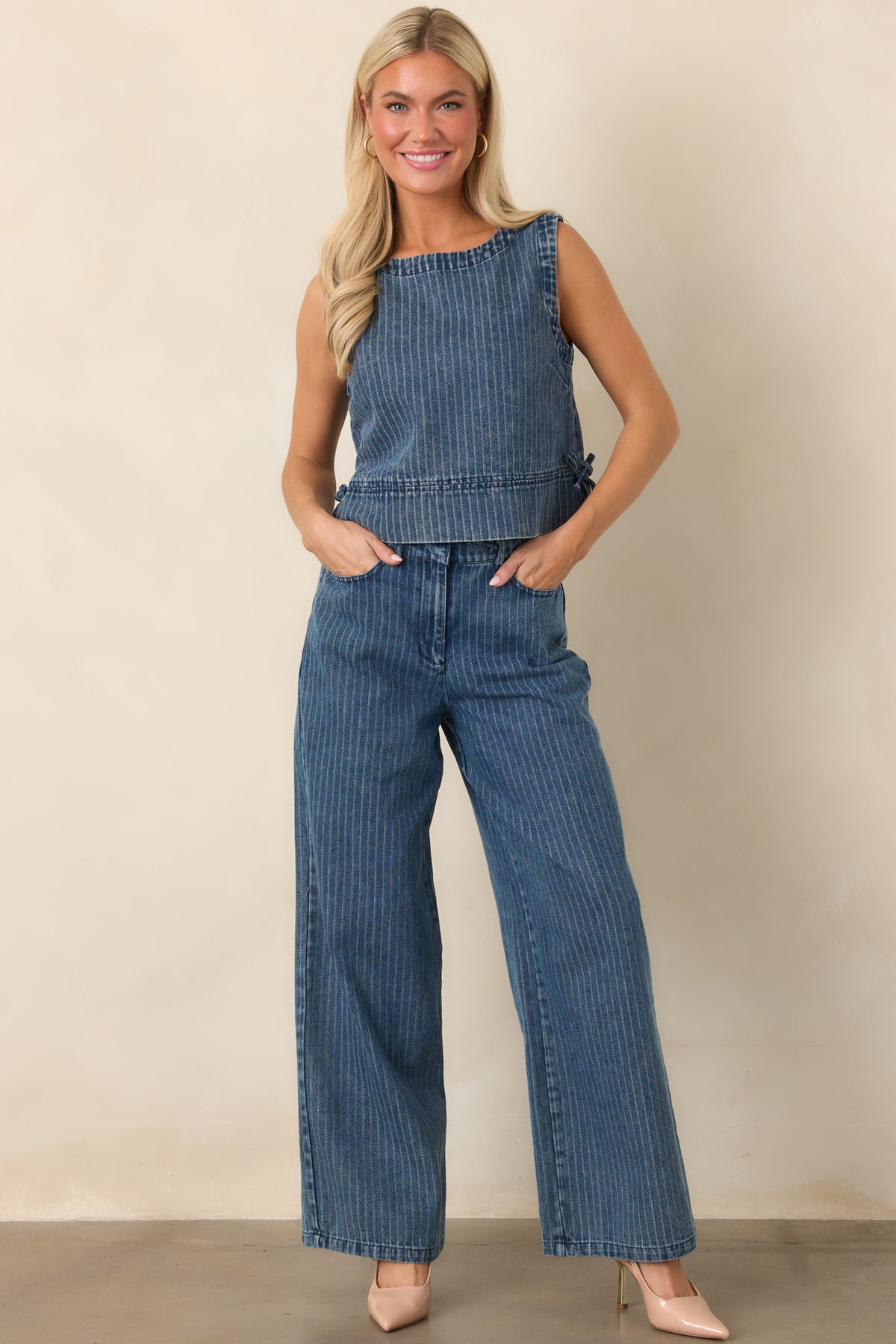 Indigo stripe pants with a relaxed wide-leg silhouette, soft cotton-blend denim construction, elastic waistband, adjustable drawstring, and convenient side pockets.