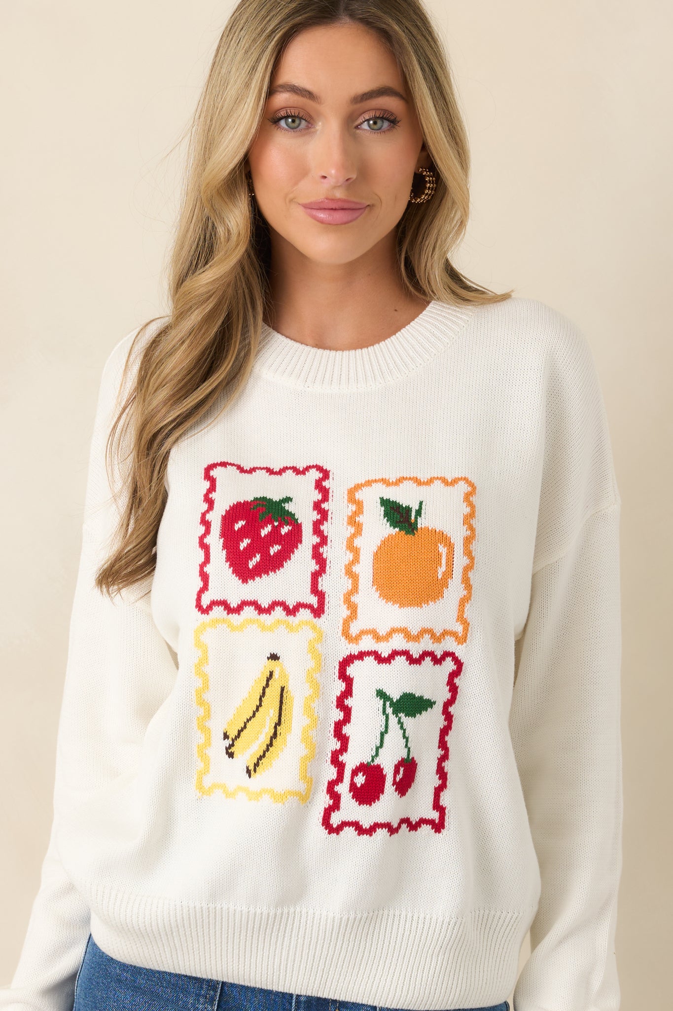 Soft knit pullover showing vintage-inspired fruit illustrations.