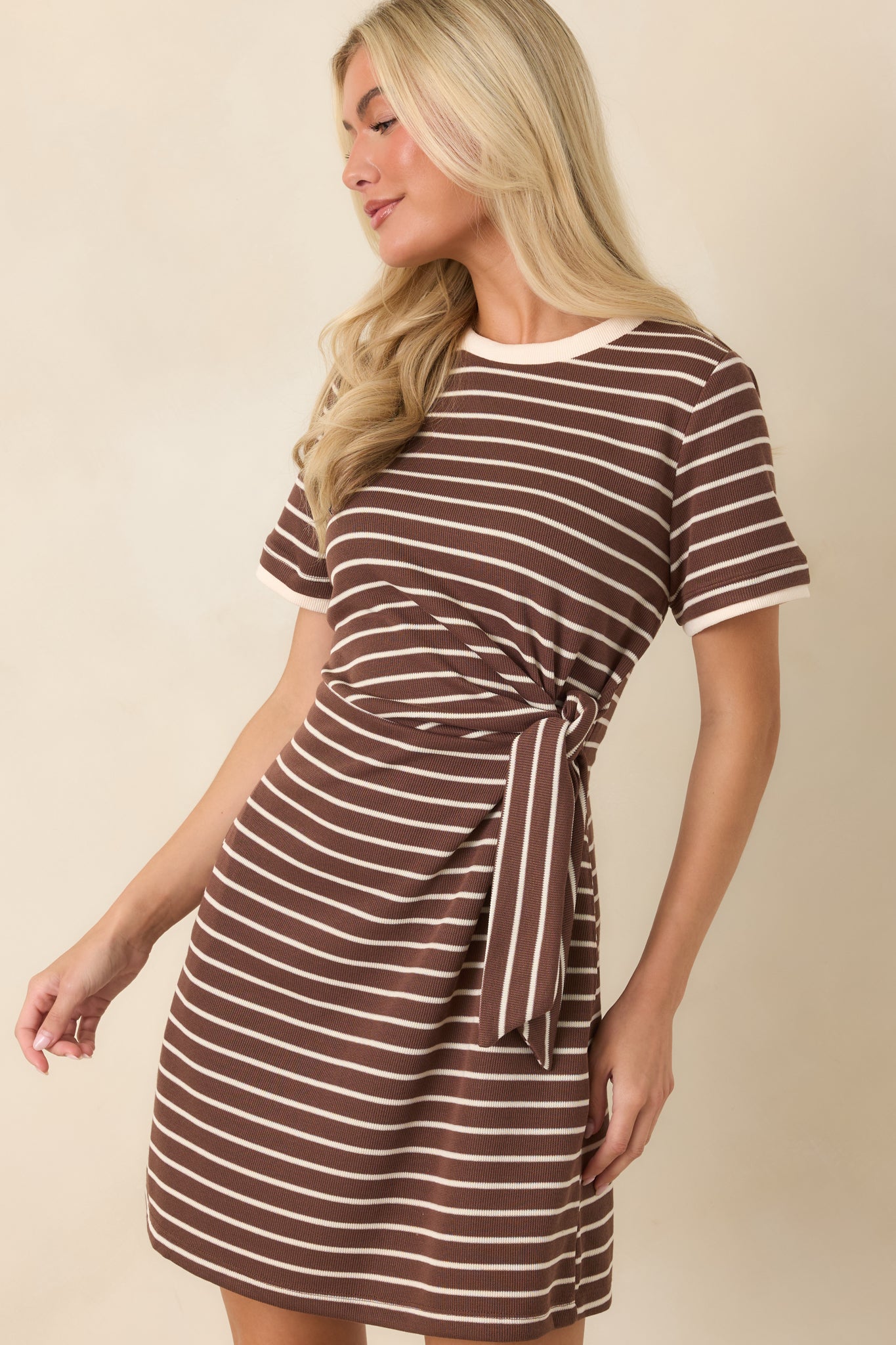 Soft knit striped dress showcasing the sporty contrast trim and flattering waist-defining silhouette.