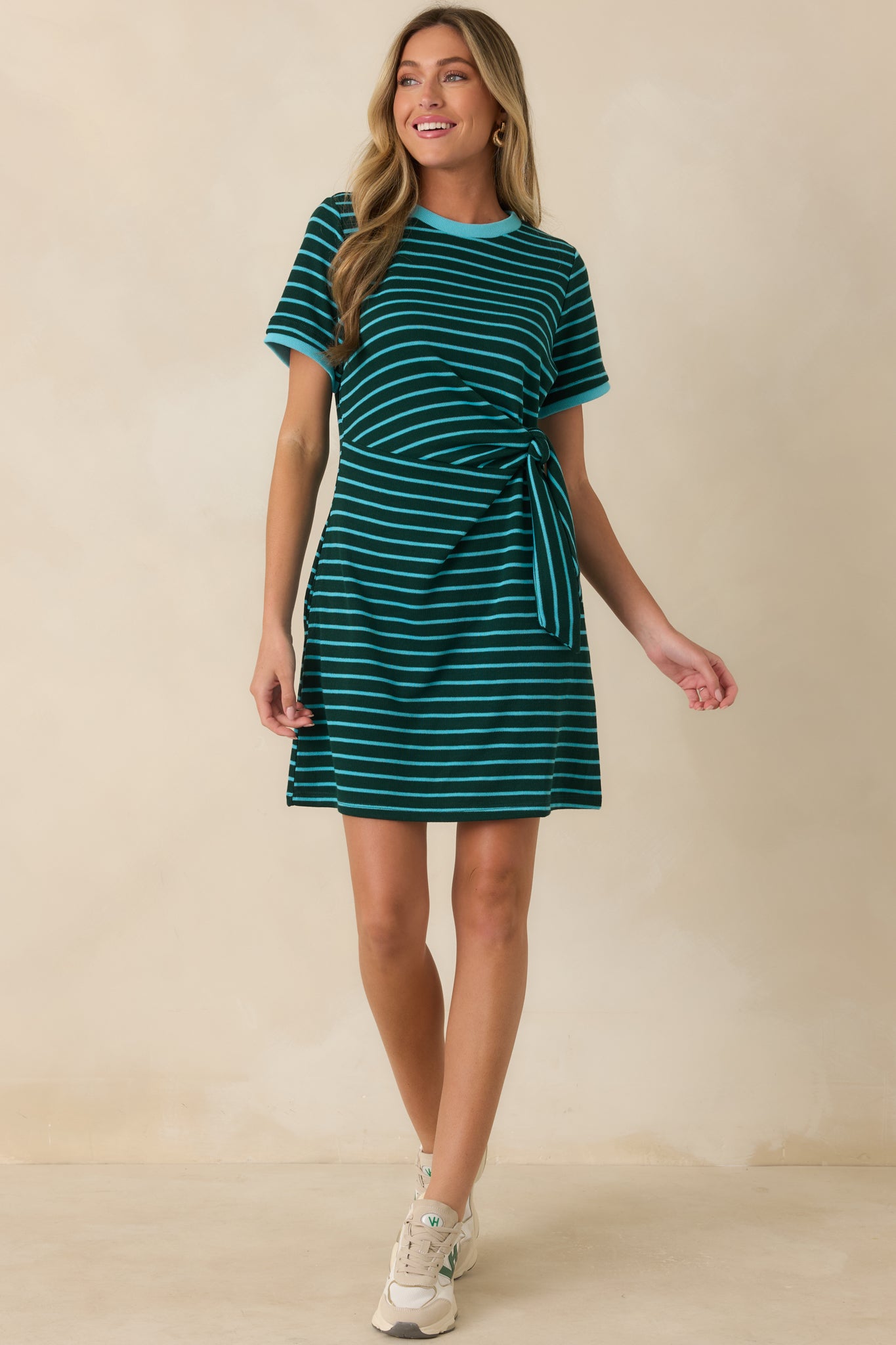 Soft knit striped mini dress with a relaxed silhouette, contrast neckline detailing, and a side tie accent for an effortlessly polished look.
