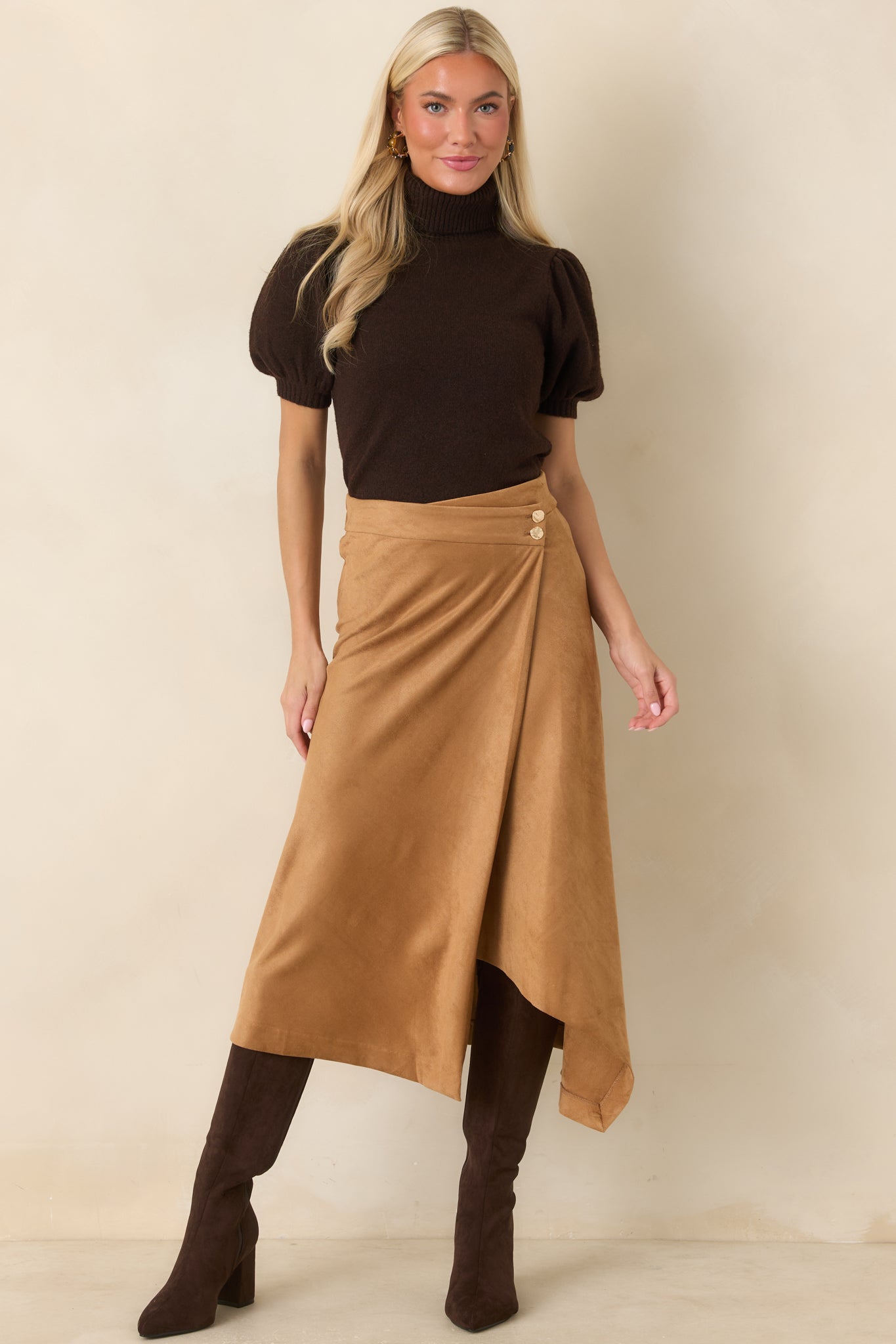 Soft knit turtleneck sweater featuring a ribbed neckline, gently gathered puff sleeves, fitted ribbed cuffs, and a streamlined silhouette finished with a ribbed hem.