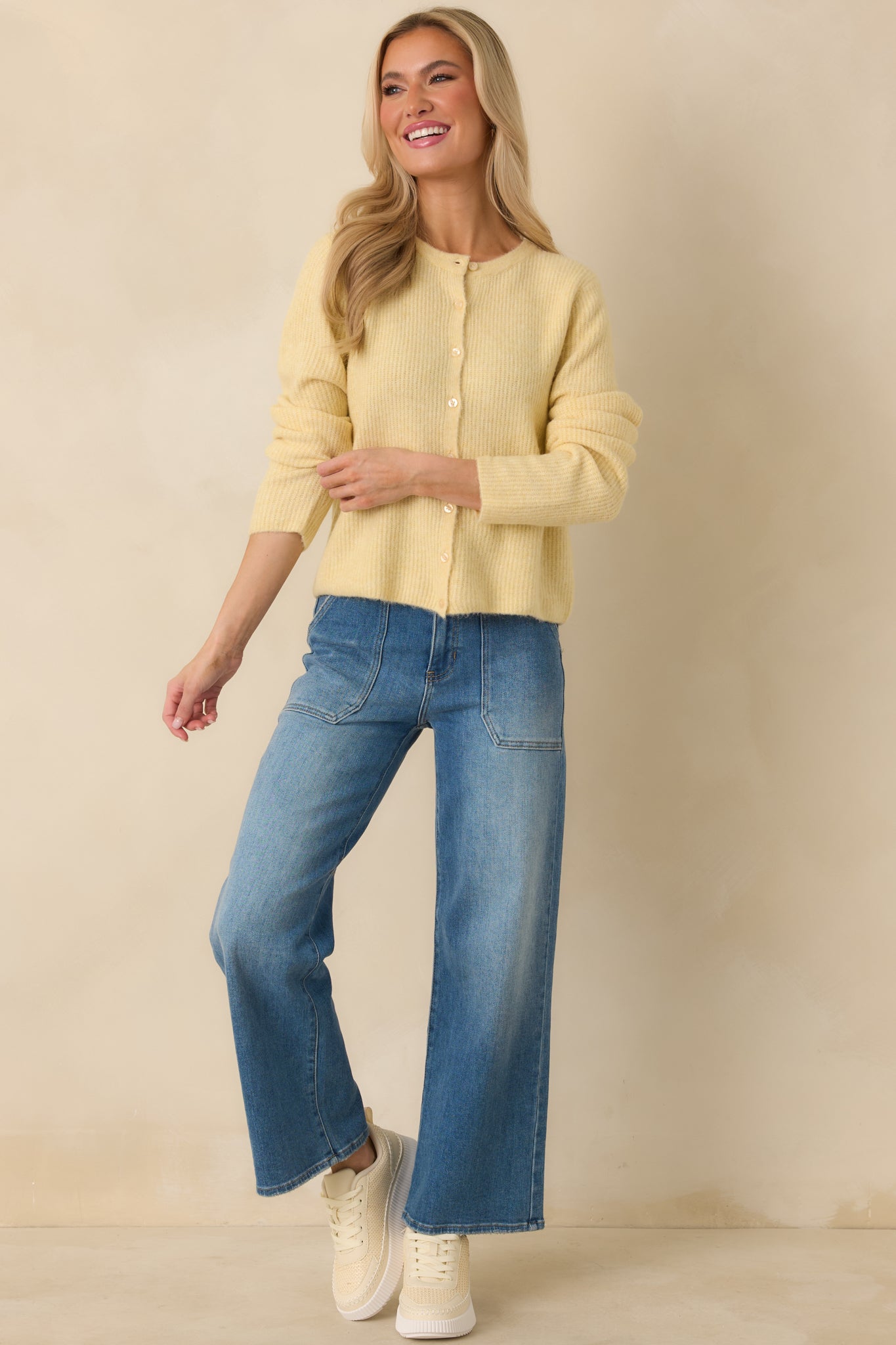 Soft light yellow cardigan featuring a full button-front closure, lightweight ribbed texture, and comfortable easy fit.