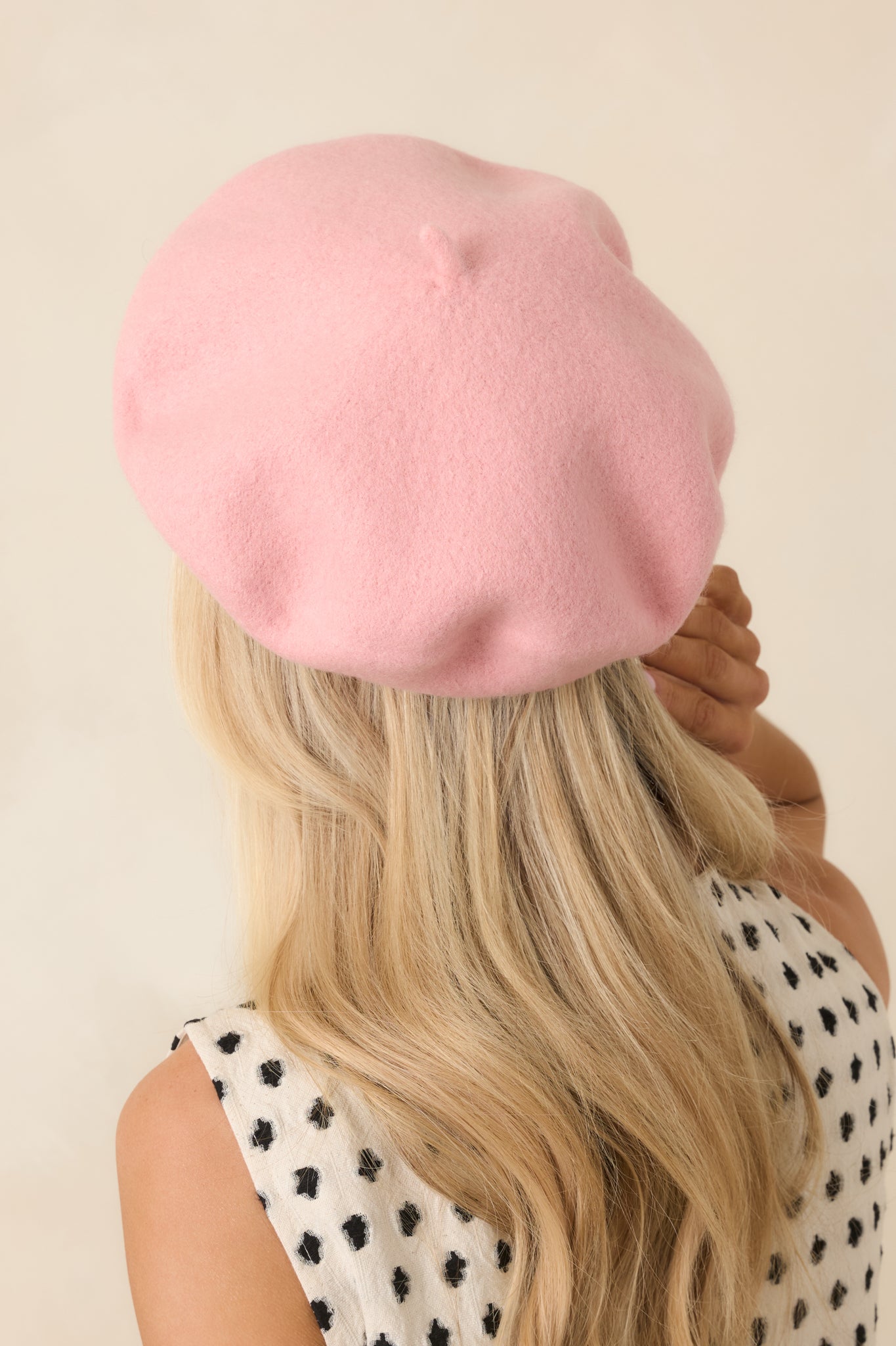 Soft pink beret showcasing a timeless design, smooth wool finish, and comfortable structured construction.