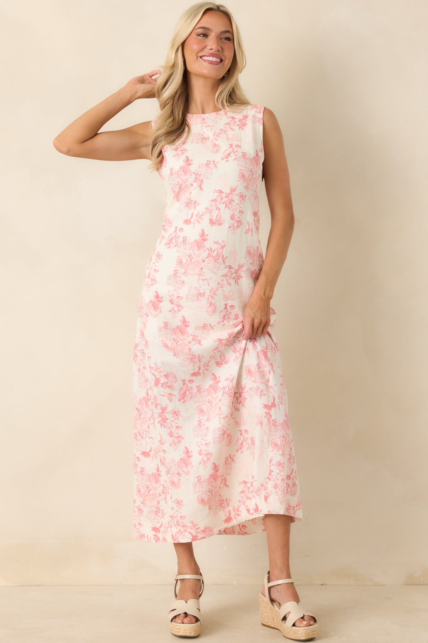 Soft pink floral maxi dress with an ivory backdrop, sleeveless styling, and a breezy full-length design that moves effortlessly.