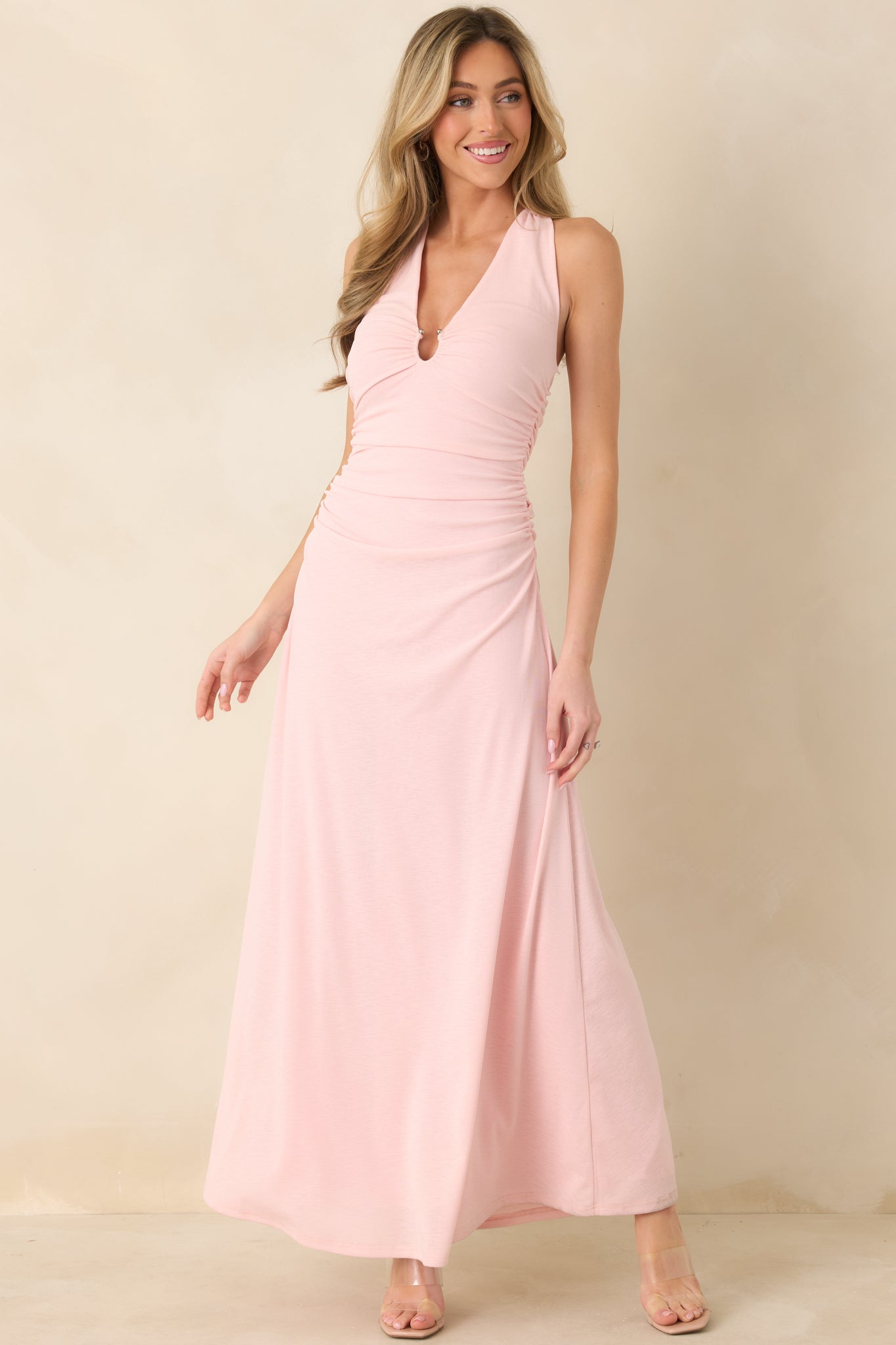 Front angle of soft pink midi dress emphasizing gathered keyhole neckline and flattering fitted silhouette.