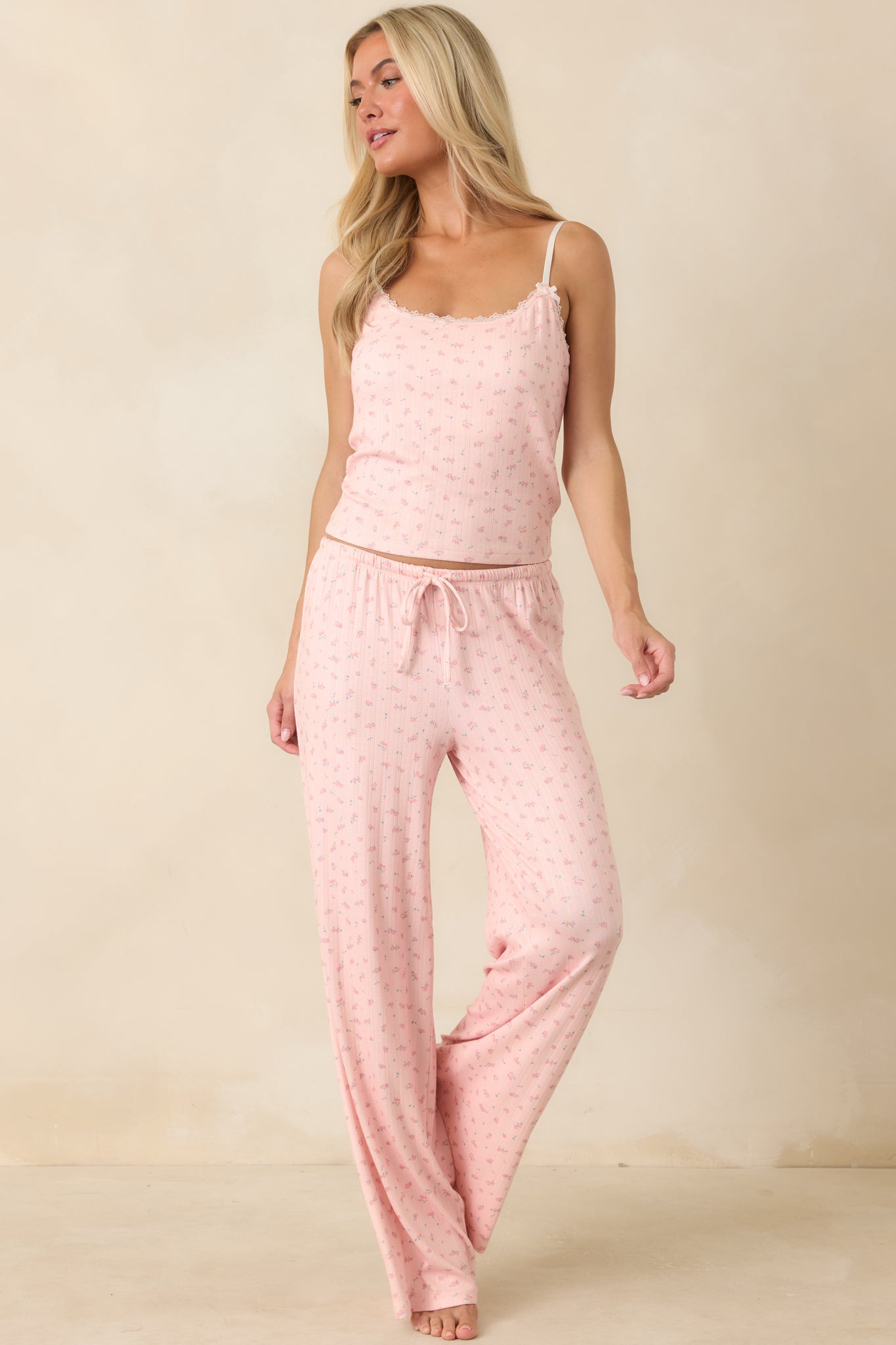 Soft pointelle pants featuring a delicate rosebud print, pull-on waistband, and an effortless draped silhouette.