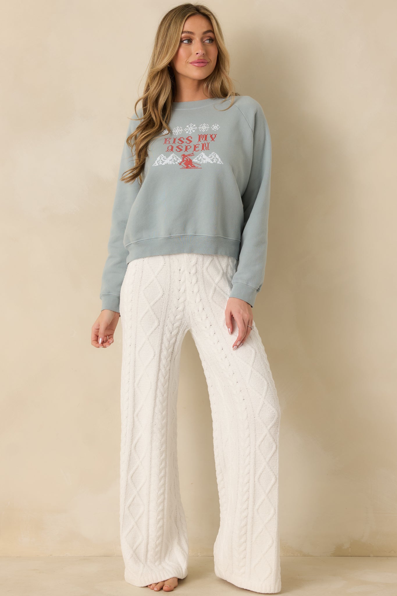 Soft slate blue sweatshirt displaying its relaxed silhouette and crisp graphic accents.